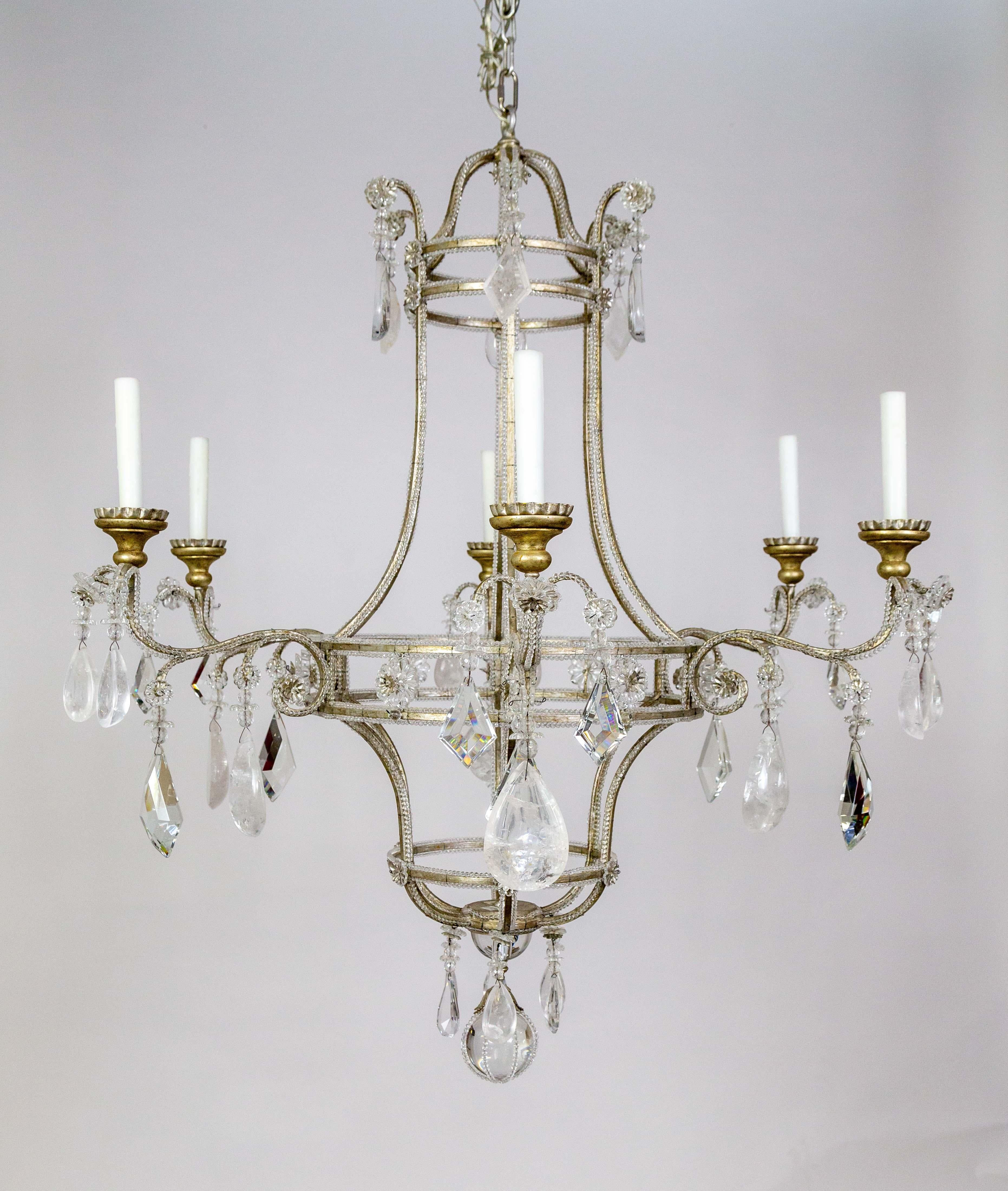 A large, birdcage style, 6-arm chandelier in silver leafed finish with an open, airy design by Dennis & Leen.  Its silvered, iron frame is lined with small crystal beads and adorned with large crystal and rock crystal drops, rosettes, and kites.