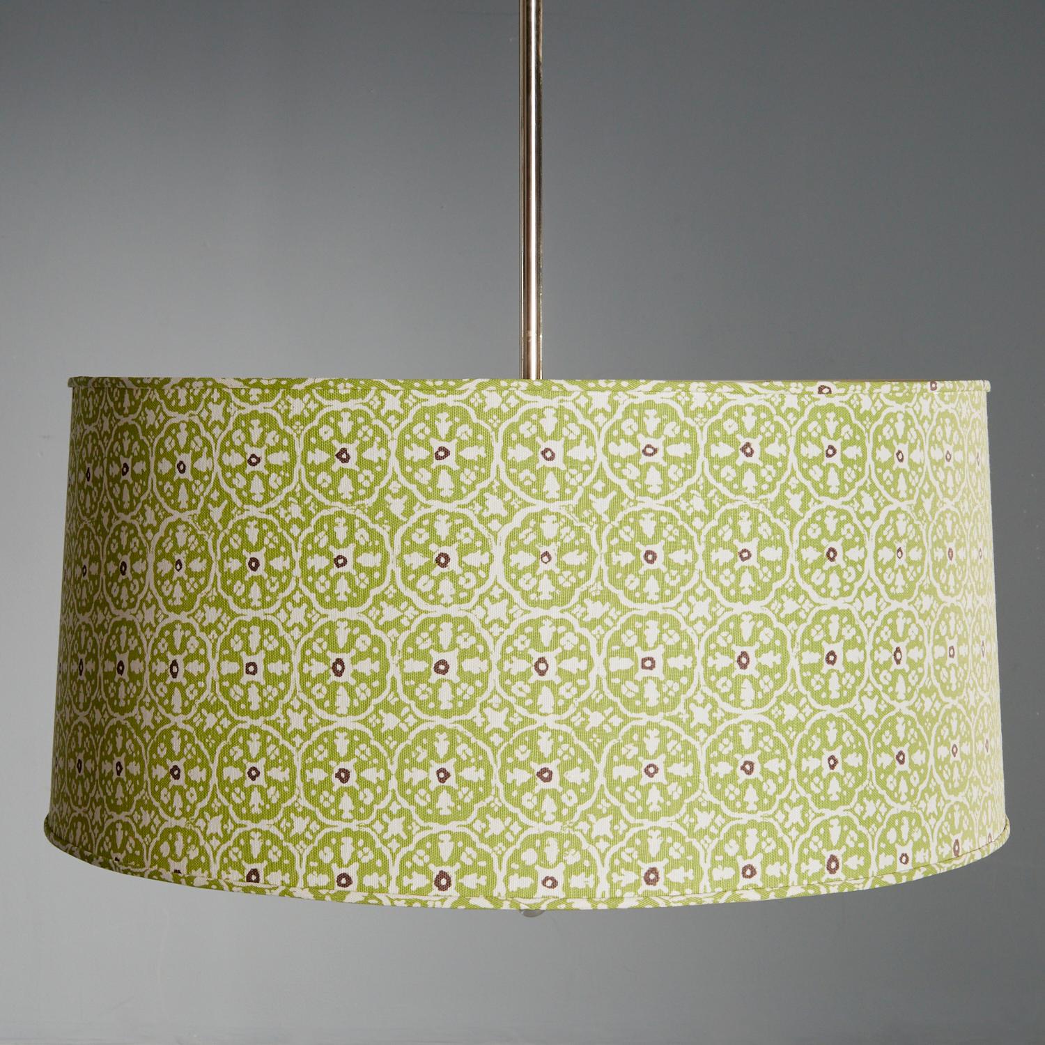 21st c., Large contemporary designer 3-light drum shade in a floral print fabric with polished nickel downrod.  No visible signature. The fabric is in an abstract green floral pattern with a small dark purple floral center, on a white