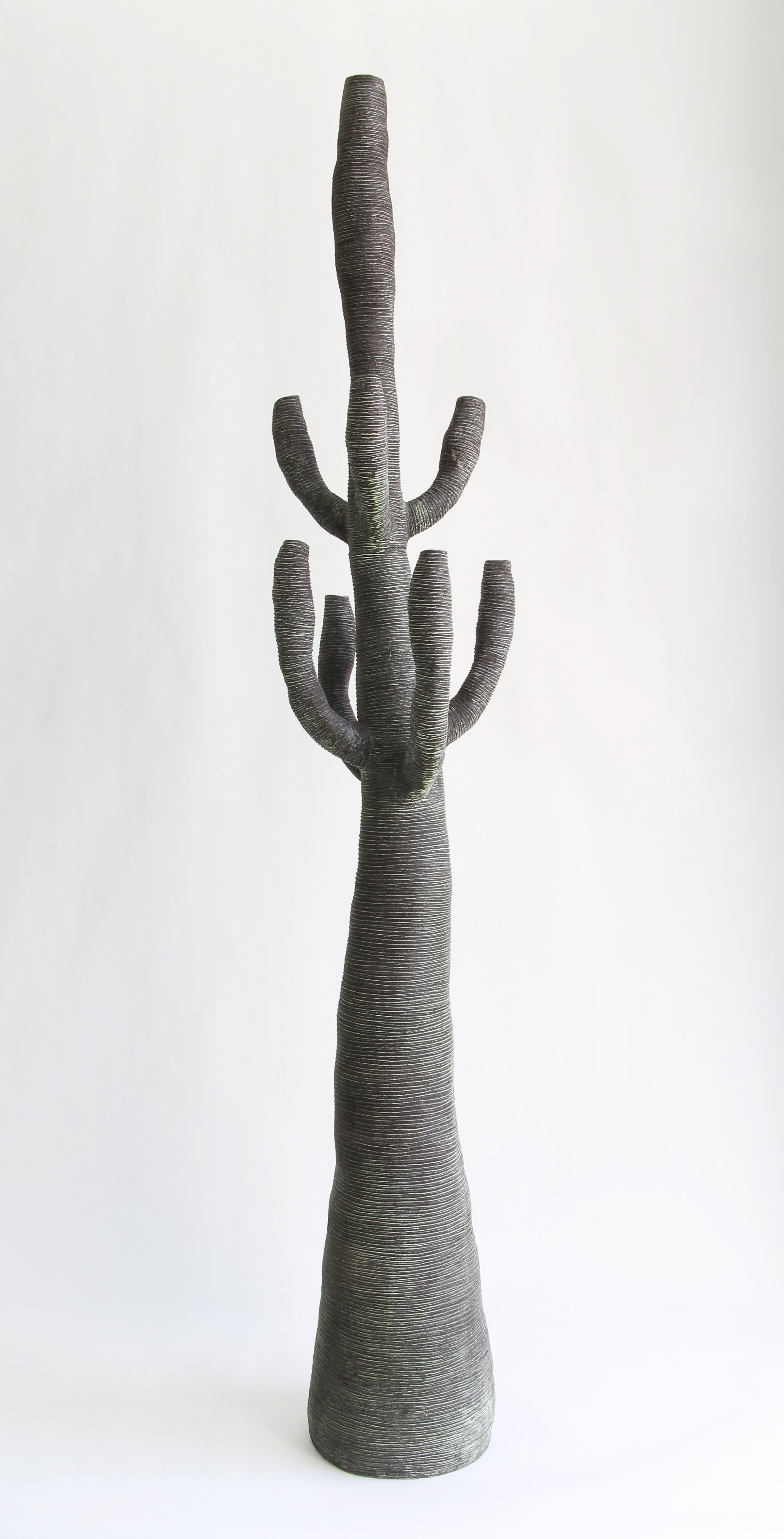 Large green ceramic cactus created by Julie Bergeron. The organic forms and rich textures express the intense beauty of nature in all its irregularity. Rich variations in color, from deep brown or black to pale green highlights, vibrate with the