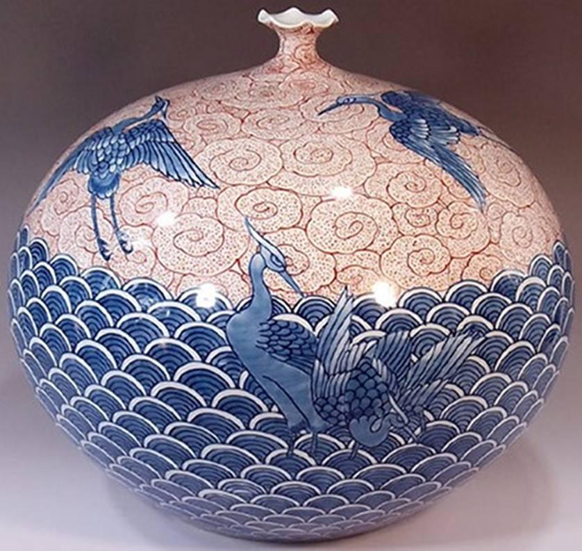Exquisite large contemporary decorative porcelain vase, intricately hand painted on a stunningly shaped ovoid Fine porcelain body in blue and red. It is a work by widely acclaimed master porcelain artist in traditional patterns of the Imari-Arita