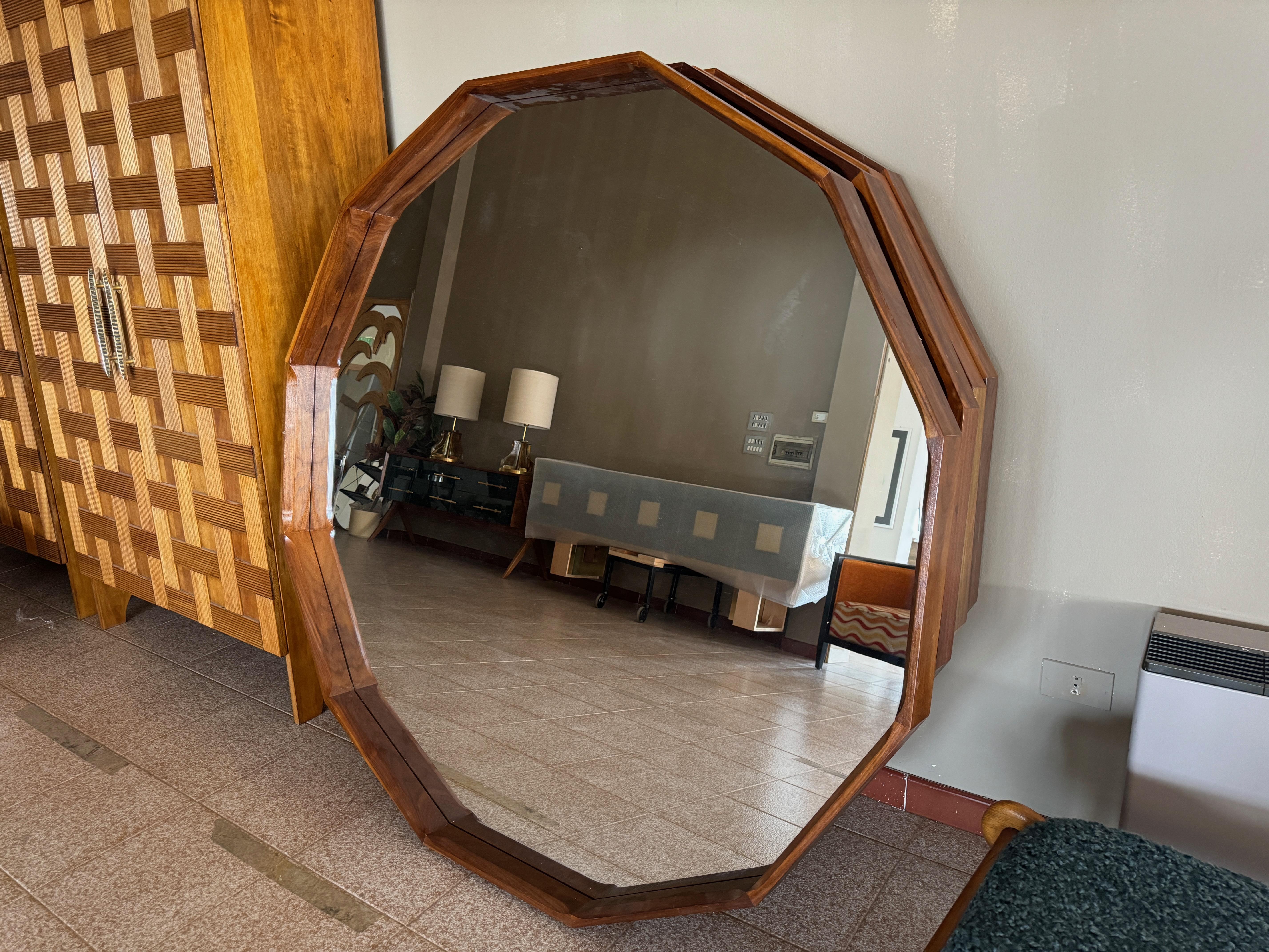 Large mirror

Stained walnut frame

Dodecagonal

Made in Italy

Can be made to order in any quantity.

This contemporary mirror features a striking dodecagonal (12-sided) wooden frame, exuding a blend of modern geometry and natural elegance. The