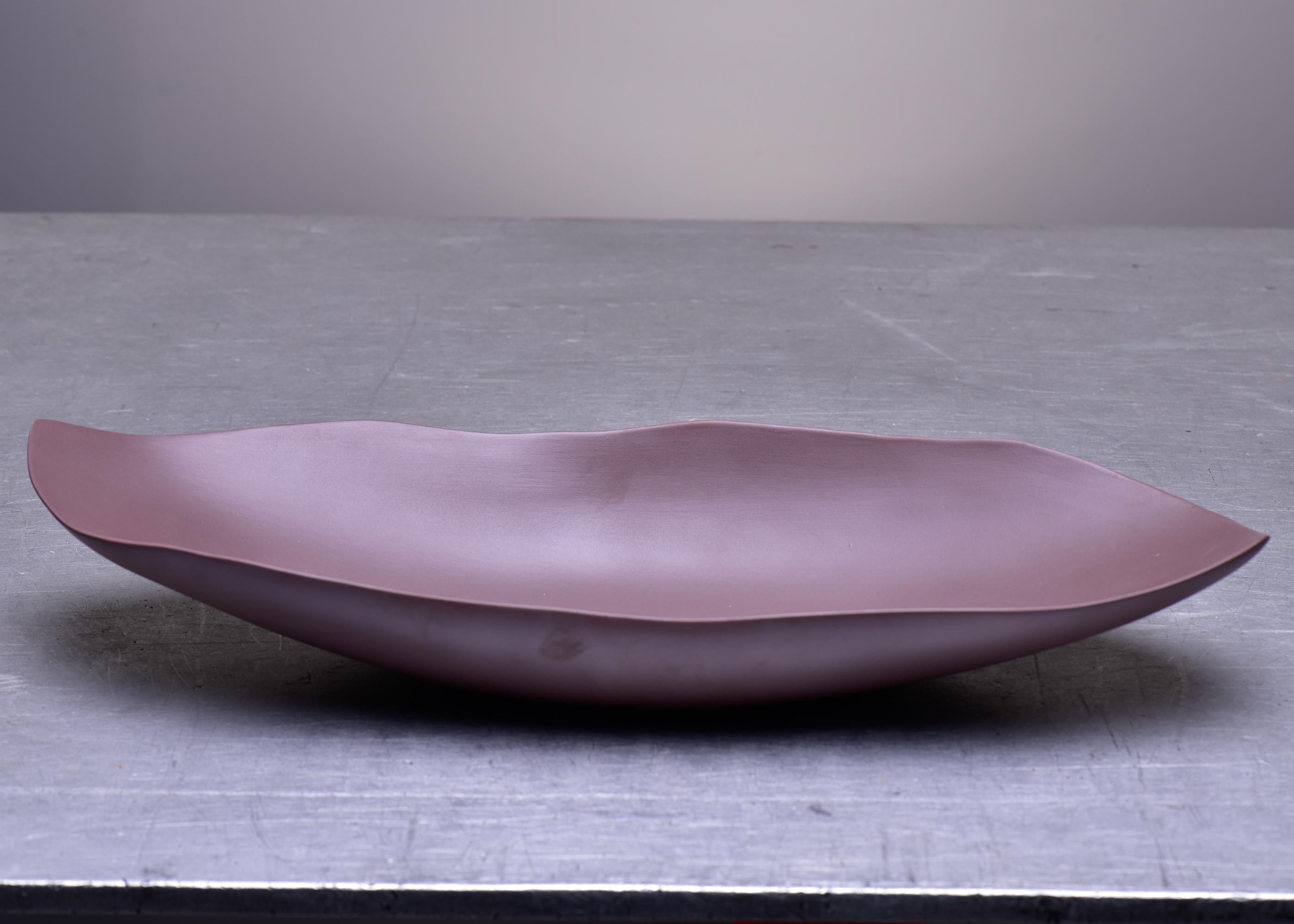 Just under 20” in length, this elongated centerpiece bowl by Italian maker Rina Menardi has elegant, thin walls with a slightly irregular edge in a smoky plum colored glaze. Marked by maker on underside of base. 
 
