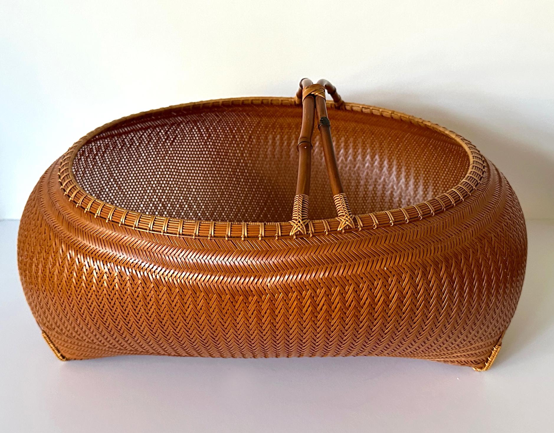 A beautiful bamboo sculpture in an Ikebana basket form by contemporary Japanese bamboo artist Kawano Shoko (born 1957-). The piece was made in 2005 and purchased from Tai Modern in 2009. The voluminous basket features the signature style of the