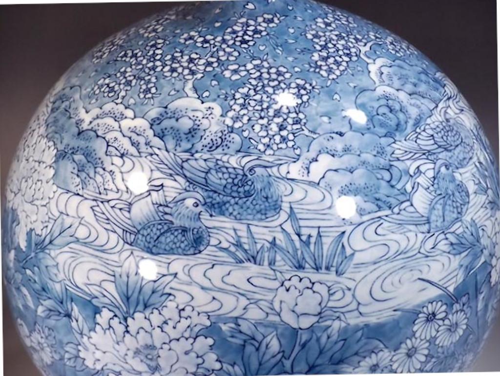 Striking Japanese contemporary decorative porcelain vase, intricately hand painted in cobalt blue underglaze on a beautifully shaped porcelain body, a signed work by highly acclaimed award-winning master porcelain artist from the historic