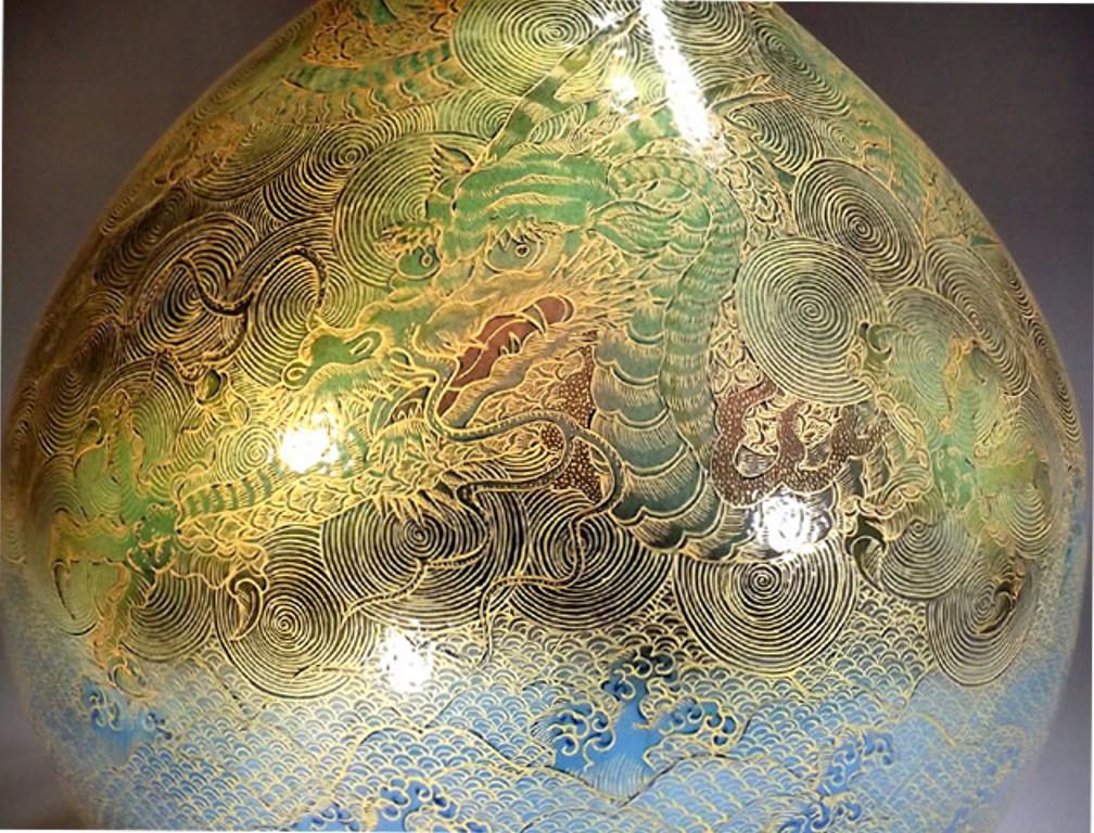 Outstanding contemporary large Japanese decorative porcelain vase, hand painted in extremely intricate patterns and extensive use of gold on vibrant blue and green on a stunning bottle shaped porcelain body, featuring the auspicious “dragon and