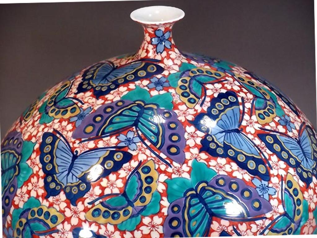Exquisite large Japanese contemporary porcelain decorative vase, intricately hand painted in vivid blue, red and green on a beautifully shaped porcelain body, a signed piece by a master porcelain artist in the Imari-Arita tradition. In 2016, the