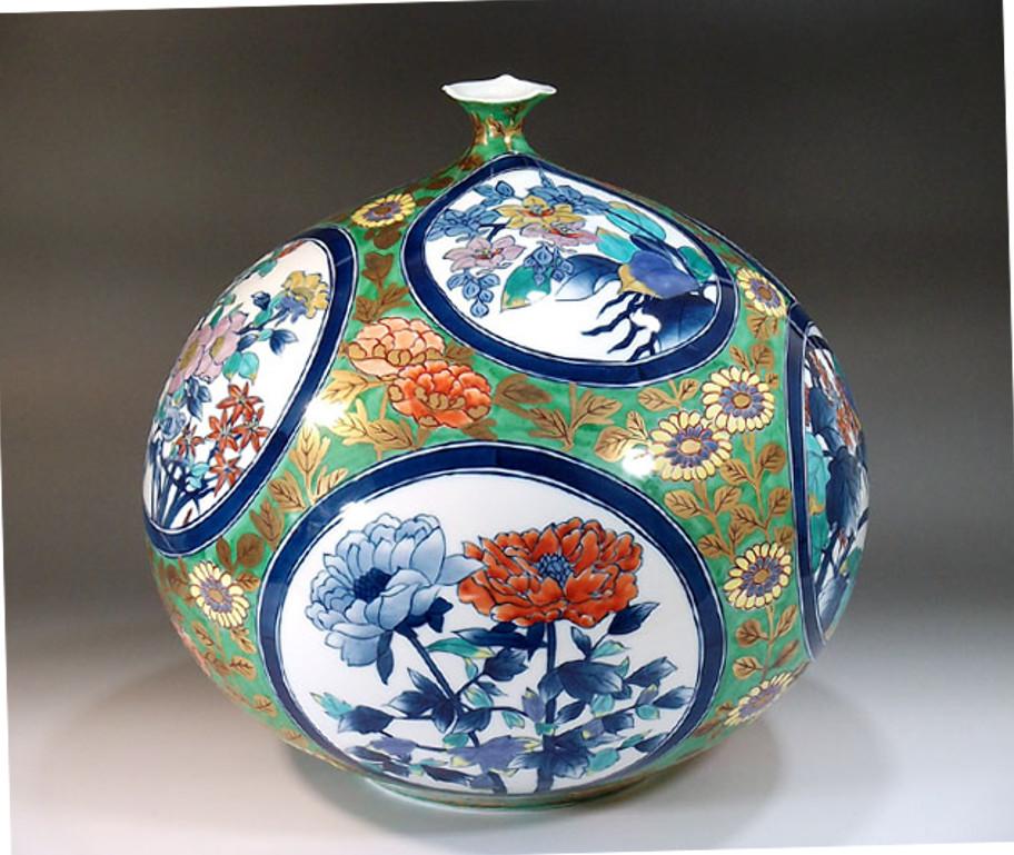 Exquisite contemporary Japanese decorative Porcelain vase, intricately gilded and hand painted in hues of red, blue and green on a striking ovoid body, a signed work by highly acclaimed award-winning master porcelain artist of the Imari-Arita region