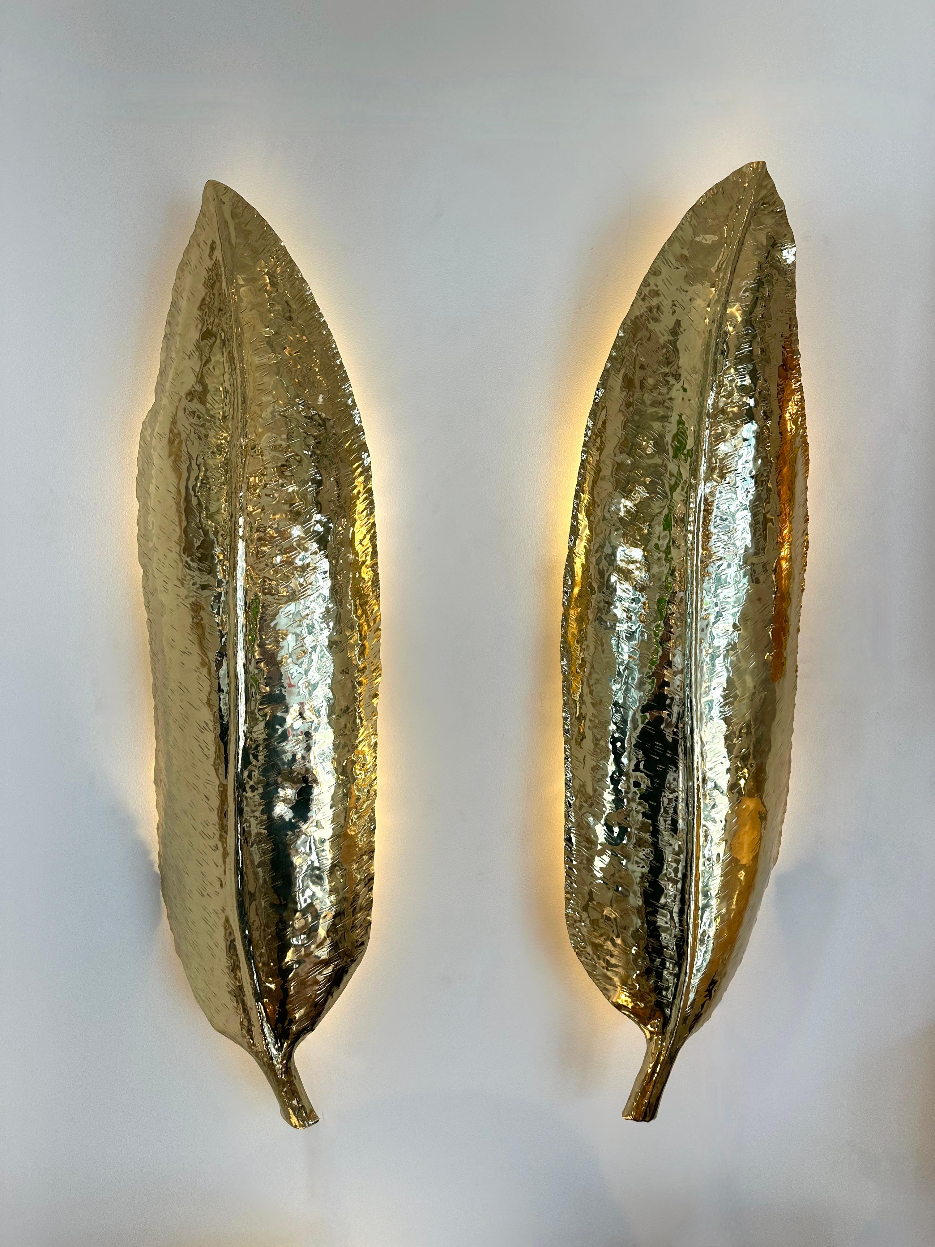 Large Pair of hammered brass palm tree leaf wall lights lighting lamps sconces. Contemporary work from a small artisanal italian design workshop. Minor imperfections due to artisanal hand made. In the mood of Mid-Century Modern, Hollywood Regency,