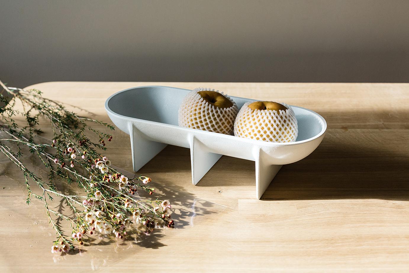 Place this unique design on a favorite table for the perfect centerpiece or enjoy in the kitchen as a special fruit bowl. 

The die cast aluminum standing bowl is elevated off the table surface by its architecturally inspired planar legs. Each