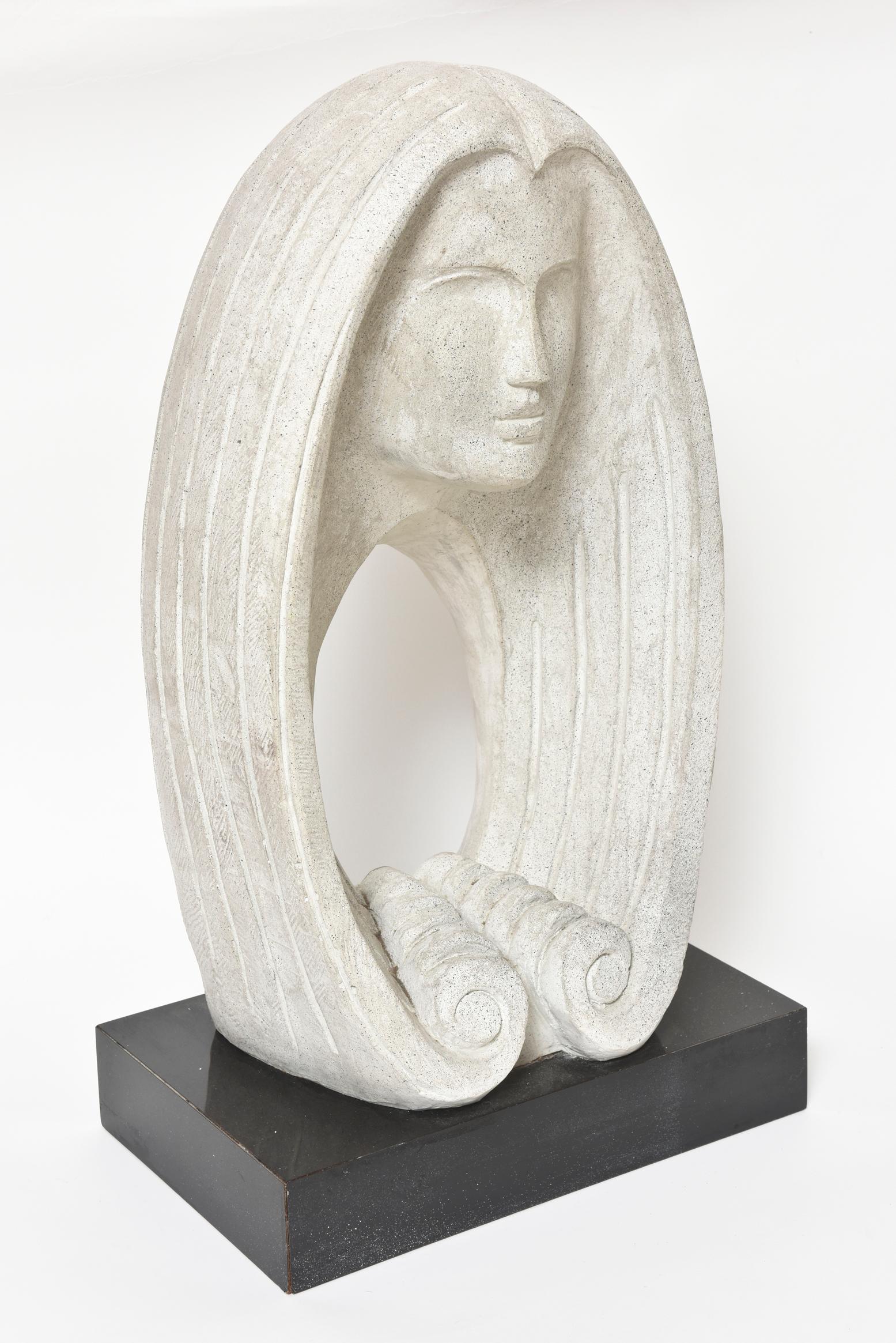 An Austin Productions Inc. sculpture of an abstract woman's face with long hair and a textured finish. Signed on side FISHER meaning David Fisher, who designed many pieces done by Austin. A very pretty modern/contemporary piece made of a white stone