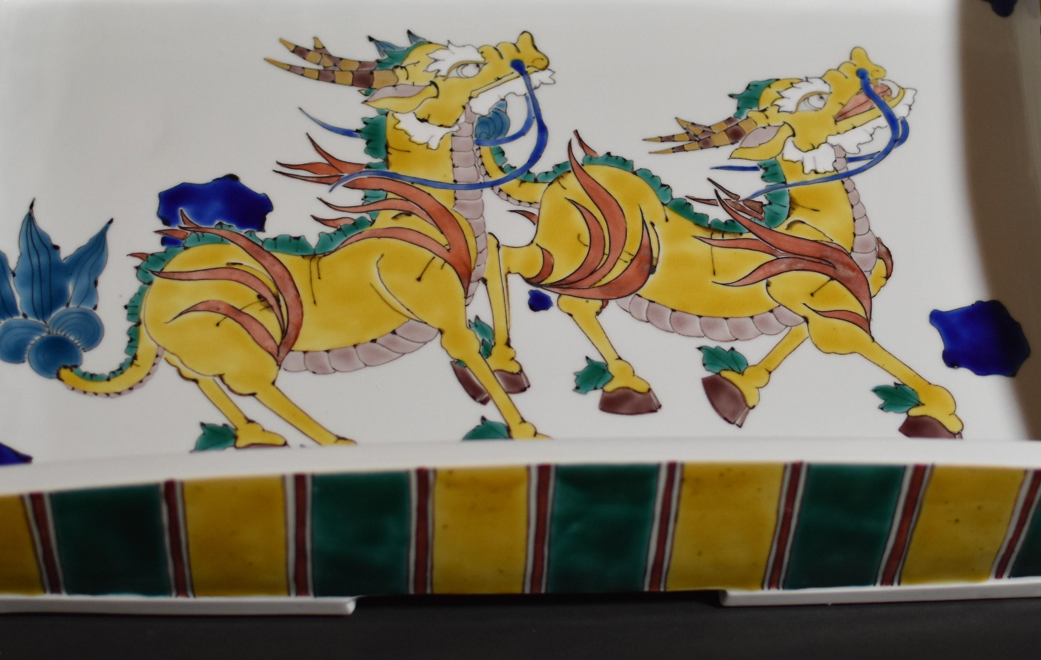 Extraordinary Japanese contemporary museum-quality signed decorative porcelain charger, stunningly hand-painted on a beautiful rectangular-shaped body with a unique interpretation of auspicious mythical giraffes (kirin). Depicted here on the inner