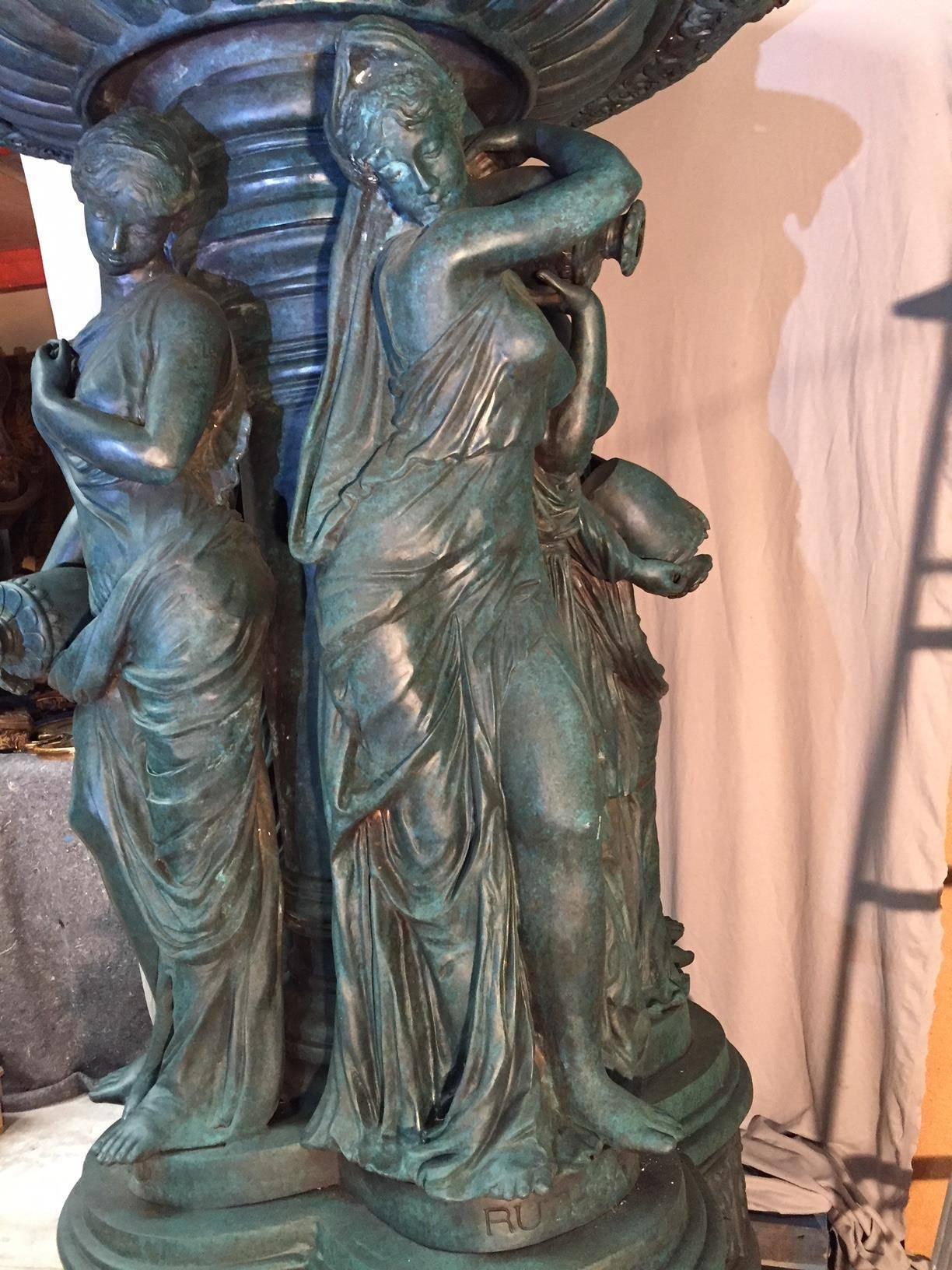 Magnificent patinated bronze garden fountain.
The upper tier with four lifesize lion's heads over a 4 1/2 foot large basin supported by four neoclassical Maidens on stepped quatrefoil plinth inscribed 