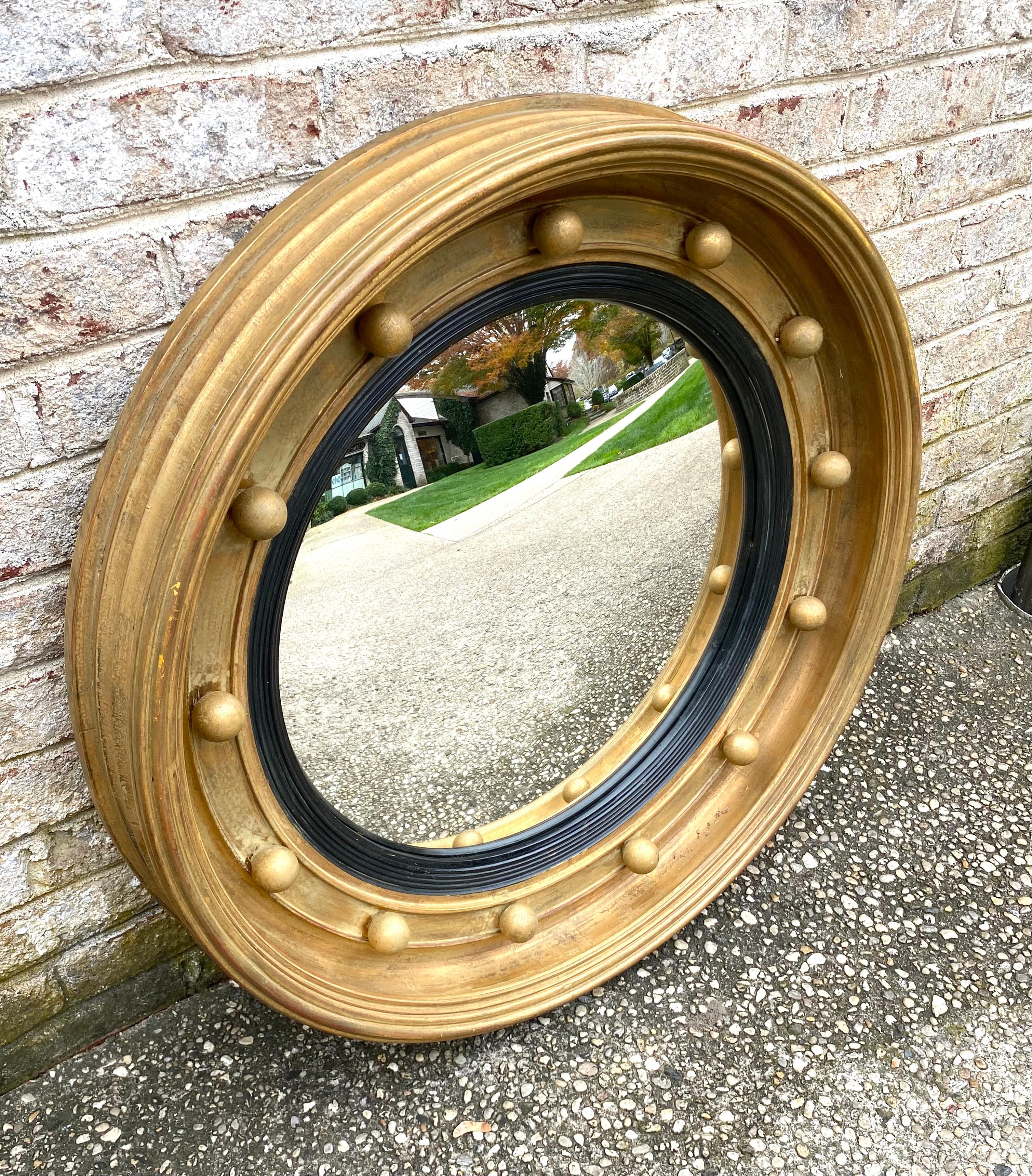 Large round gold framed convex mirror....