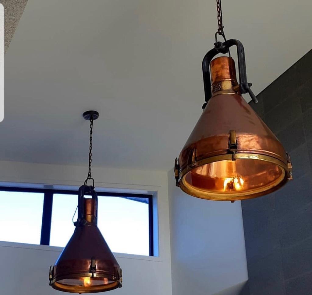 Large, magnificent and lovely copper and brass ship's deck lights converted to pendant lights. Iron U-bracket. Handles and shackle. Brass chain and canopy. Brass chain is 3' long and canopy measures 5.5