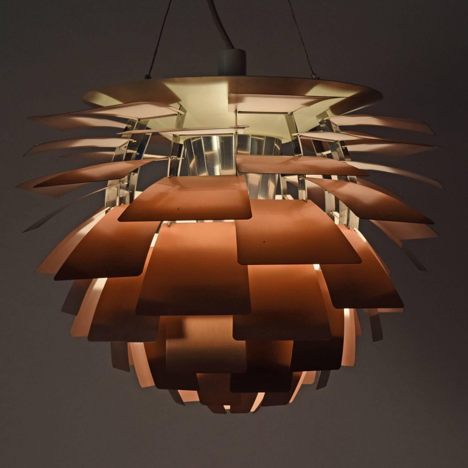 Iconic pendant lamp with solid copper leaves, very light pink enamel paint under leaves (the mark of an early production). Polished chrome socket housing and ribs. Can suspend 17'
Retains label. Made by Louis Poulsen.