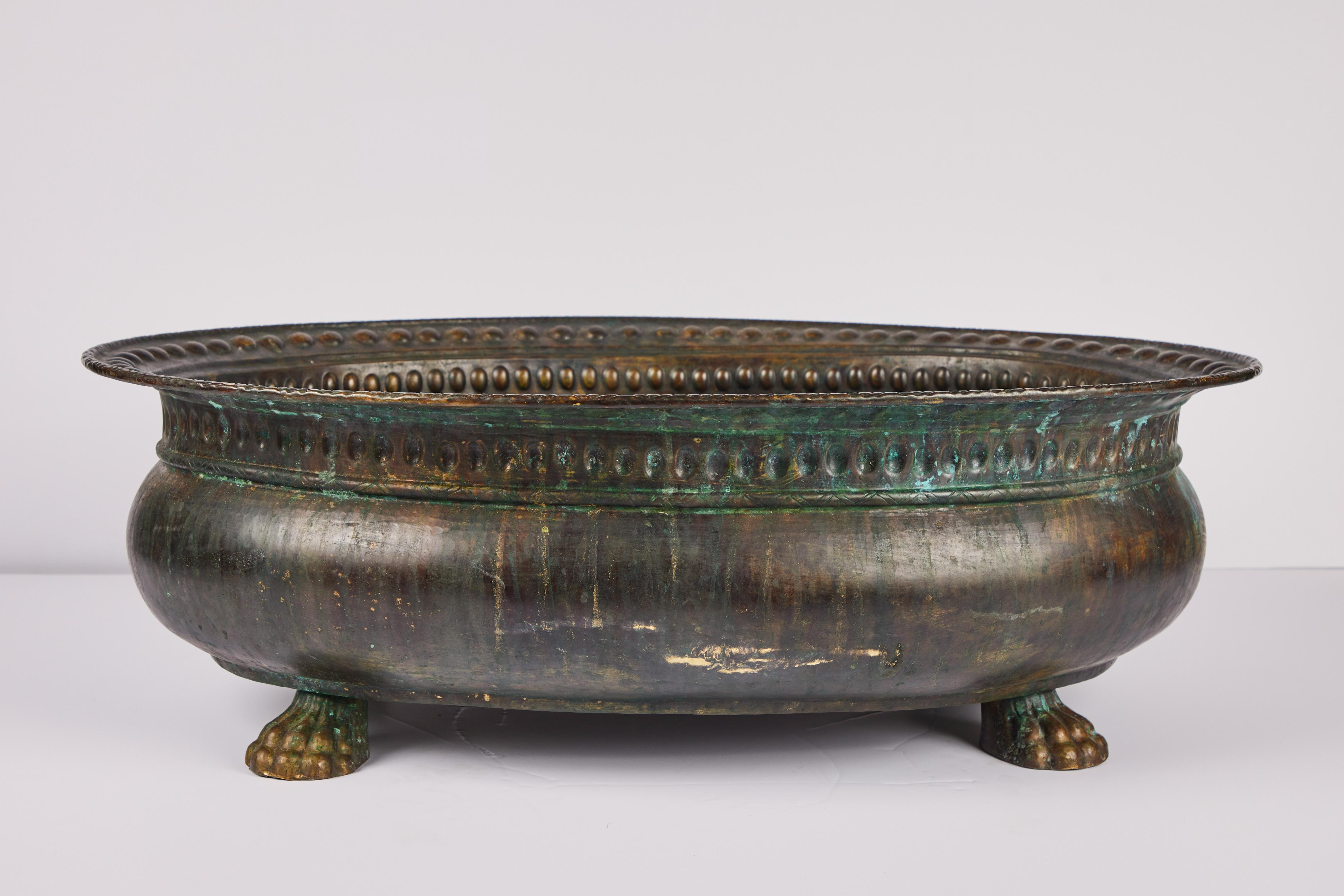 A sizable, turn-of-the-century, Italian, oval copper cachepot on a paw feet. The body surmounted by a studded lip and rim. Excellent patina.