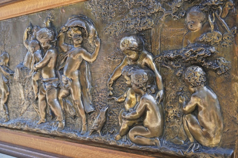 Extraordinary and unique, this gorgeous large sculptural copper panel depicting 16 charming dancing Putti, playing and amusing themselves, with 1 dog and 1 bird, after Clodion, early 20th century. The figures emerge vividly from the ground,
