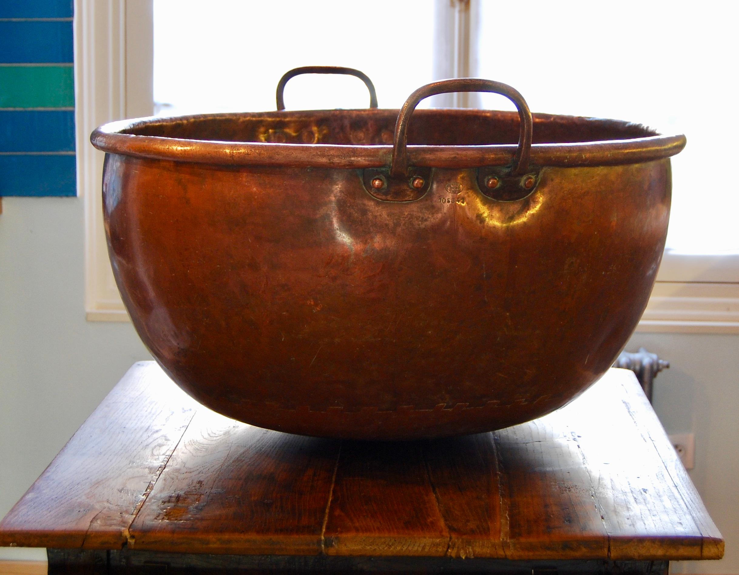This impressive hand made solid copper pot or cauldron has a rounded base and has two brass handles. 
Originating from Paris, France in the late 1800s, it is marked 'Bréhier, Paris' and is numbered No. 105341. 
As strong as it is beautiful, this pot