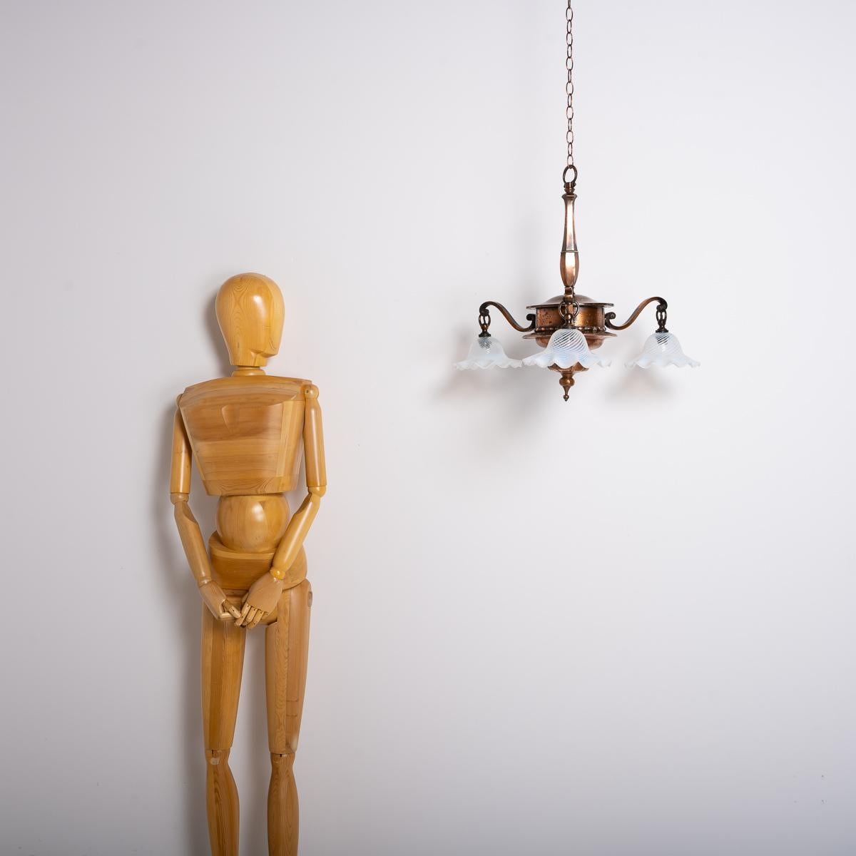 LARGE COPPER THREE-BRANCH CHANDELIER WITH JELLY OPALESCENT GLASS SHADES BY GEC

This large copper three-arm ceiling light, crafted by the General Electric Company (GEC), showcases the trademark features often seen in their designs.

Fabulous flowing