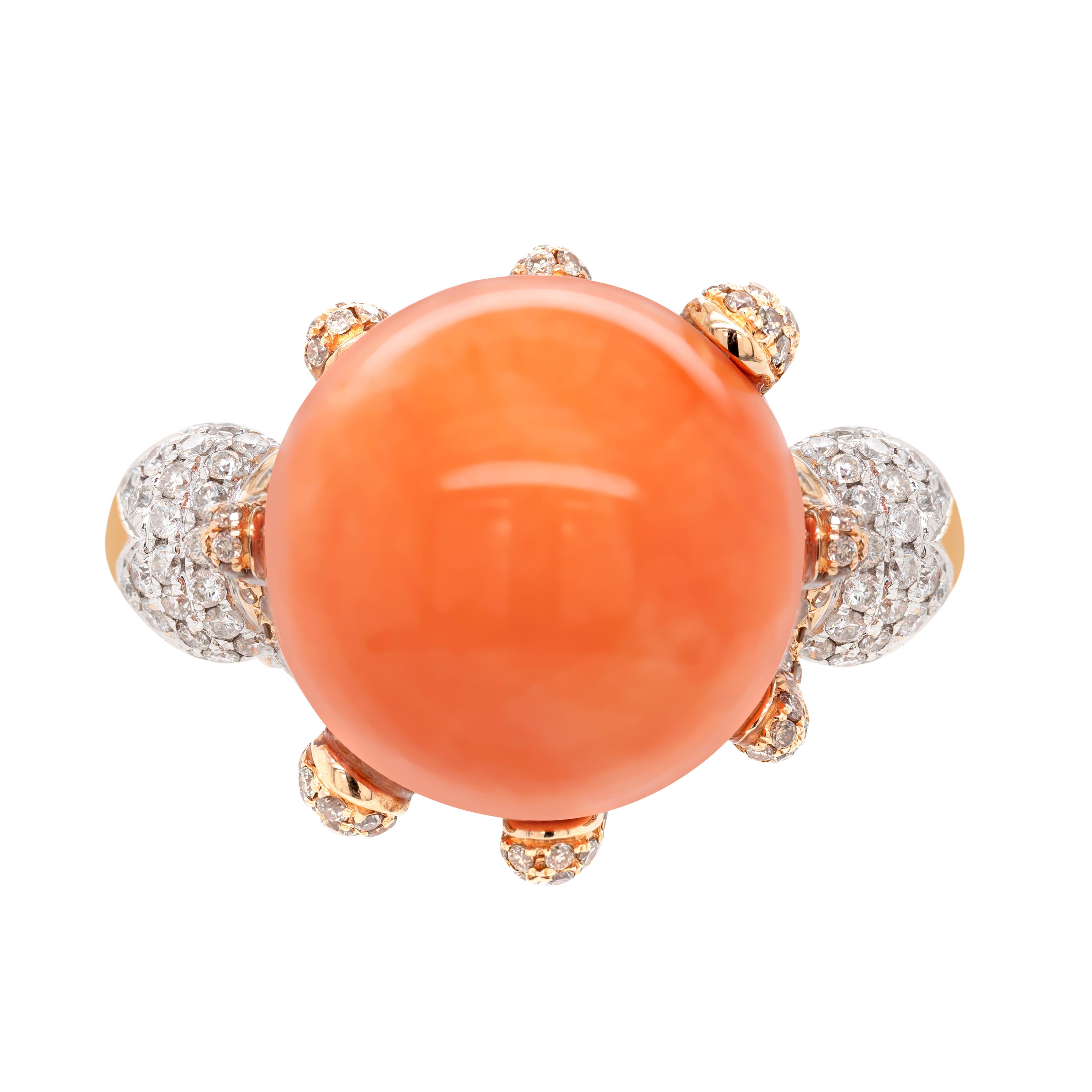 This unusual 18 carat rose gold cocktail ring features an impressive perfectly round natural coral measuring 16.5mm. The wonderful coral is securely held by 8 asymmetrical fluid claws, all masterfully micro set with round brilliant cut diamonds
