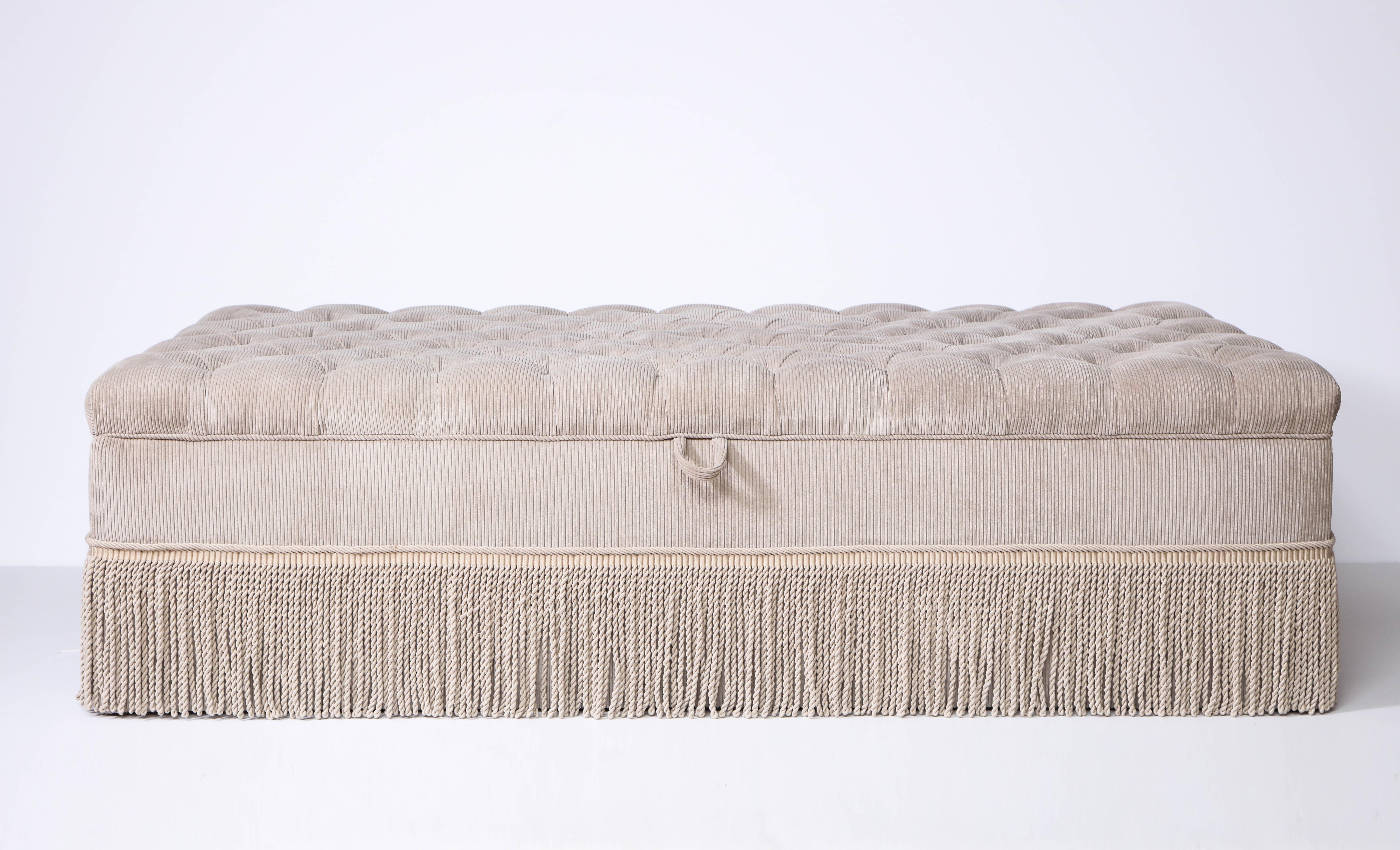 custom made corduroy tufted ottoman, upholstered in JAB Chivasso Pure Vision fabric with Samuel & Sons fringe. Hinged top opens for storage. Super soft and velvety to the touch, the piece has never been used.