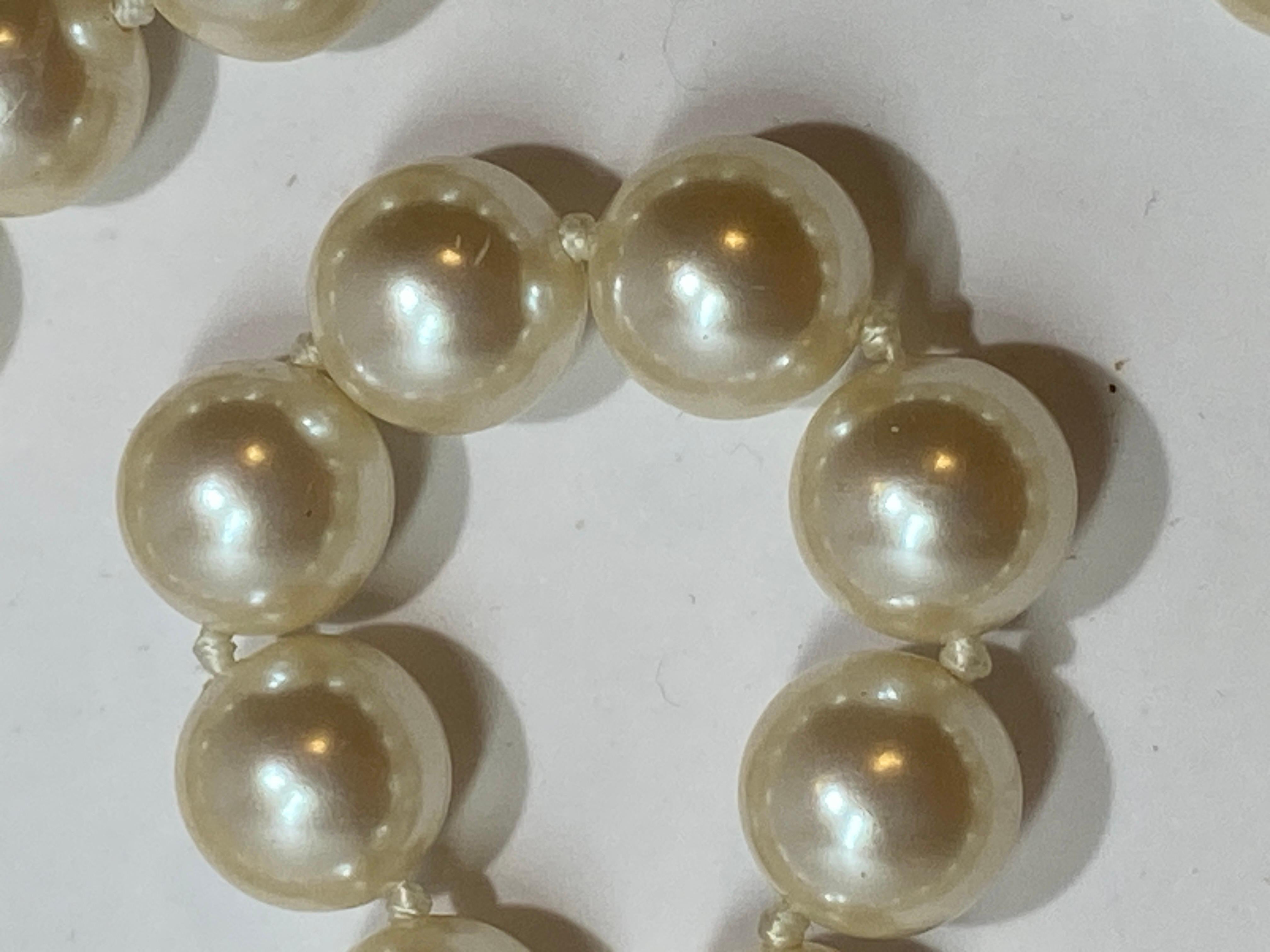 This wonderfully extra-long hand-knotted elegant Chanel-like costume pearl necklace measures 71 inches in length. The circumference of the pearls measures 1/2 inch. Made in France.