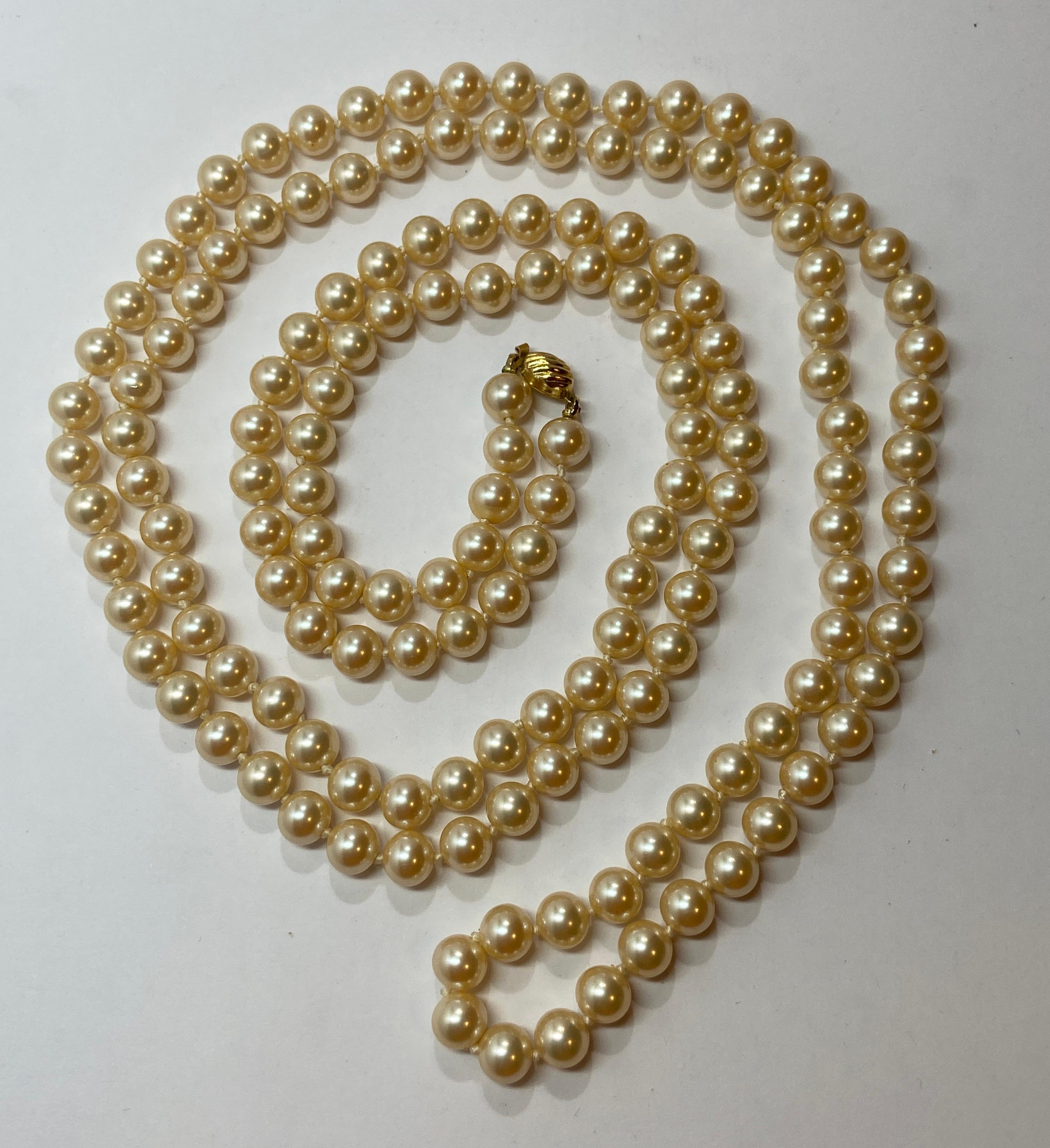 Marvella wonderfully elegant hand-knotted pearl with polished gold hardware clasp closing measures 54 inches in total length. The circumference of the pearls measures 3/8 of a inch. Made in U.S.