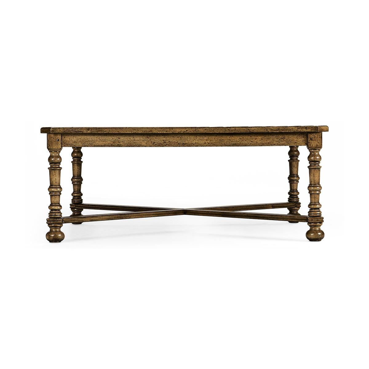Large country coffee table, heavily distressed large square parquet top coffee table in a medium drift finish with a molded edge X-frame stretcher and raised on turned legs.

Dimensions: 50
