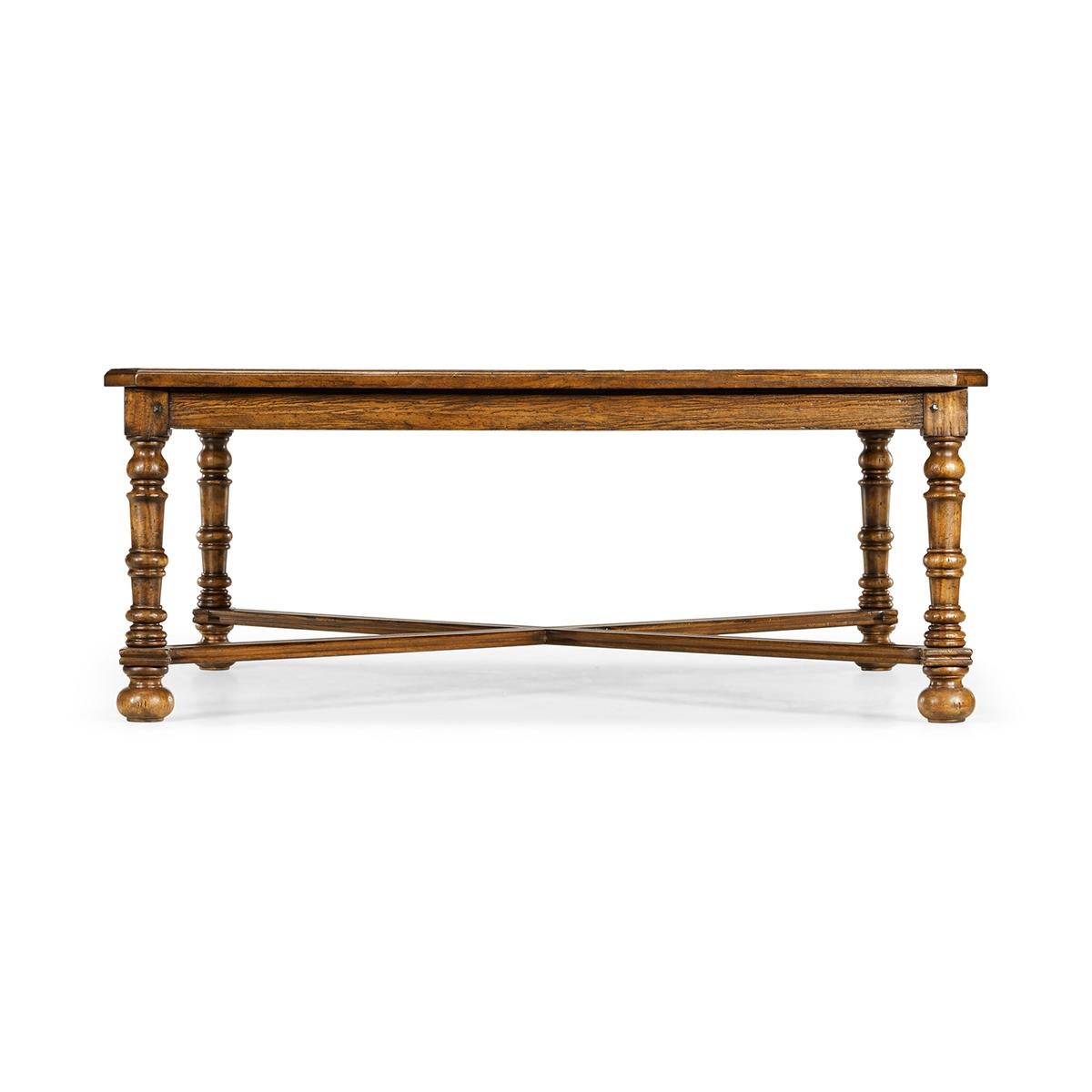 Large Country coffee table, heavily distressed large square walnut finish parquet top coffee table with a molded edge X-frame stretcher and raised on turned legs.

Dimensions: 50