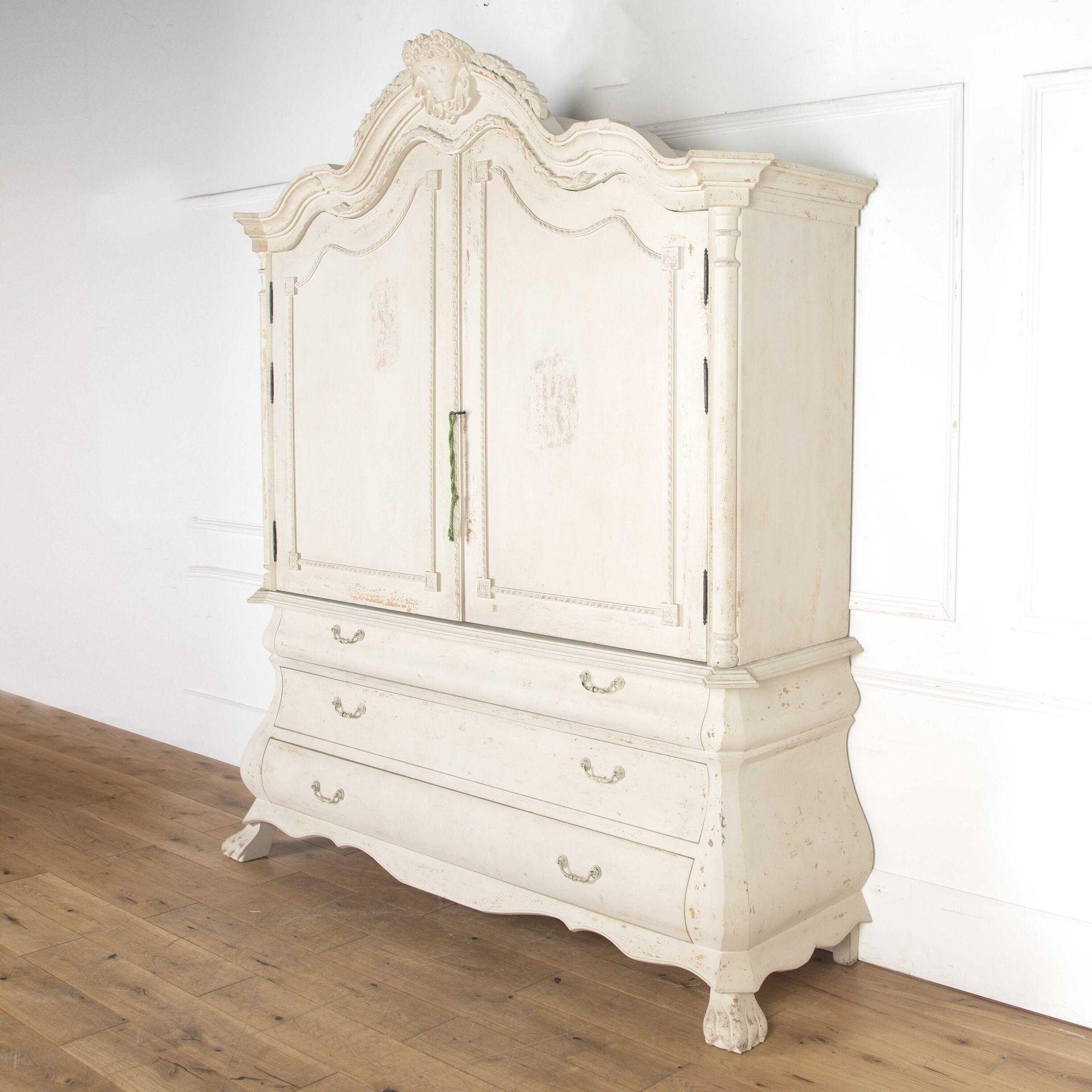 Imposing 21st century linen press from Flamant, Belgium. 
This cabinet has a dramatic presence and wonderful large proportions. 
Featuring a beautifully carved bonnet top with an elaborate central crest featuring scrolling foliate details. 
To