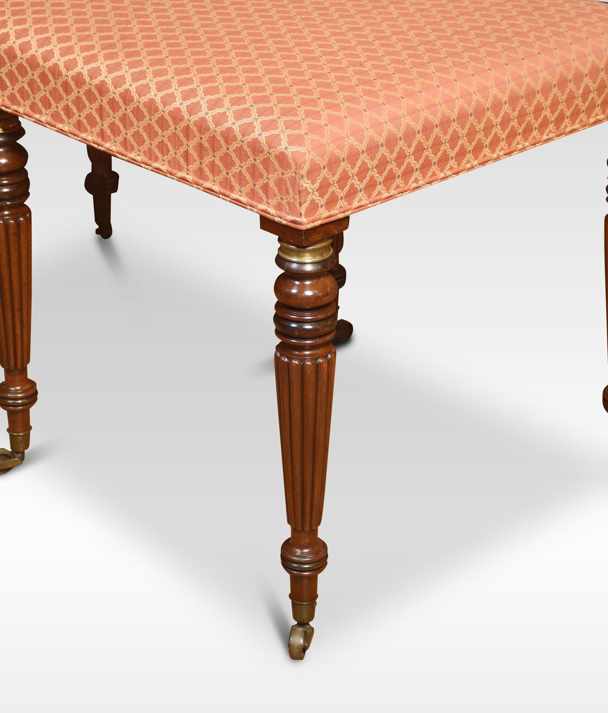 Large regency stool, the upholstered seat raised up on six mahogany turned reeded and fluted legs, terminating in brass castors.
Dimensions
Height 26.5 Inches
Width 49 Inches
Depth 27 Inches.