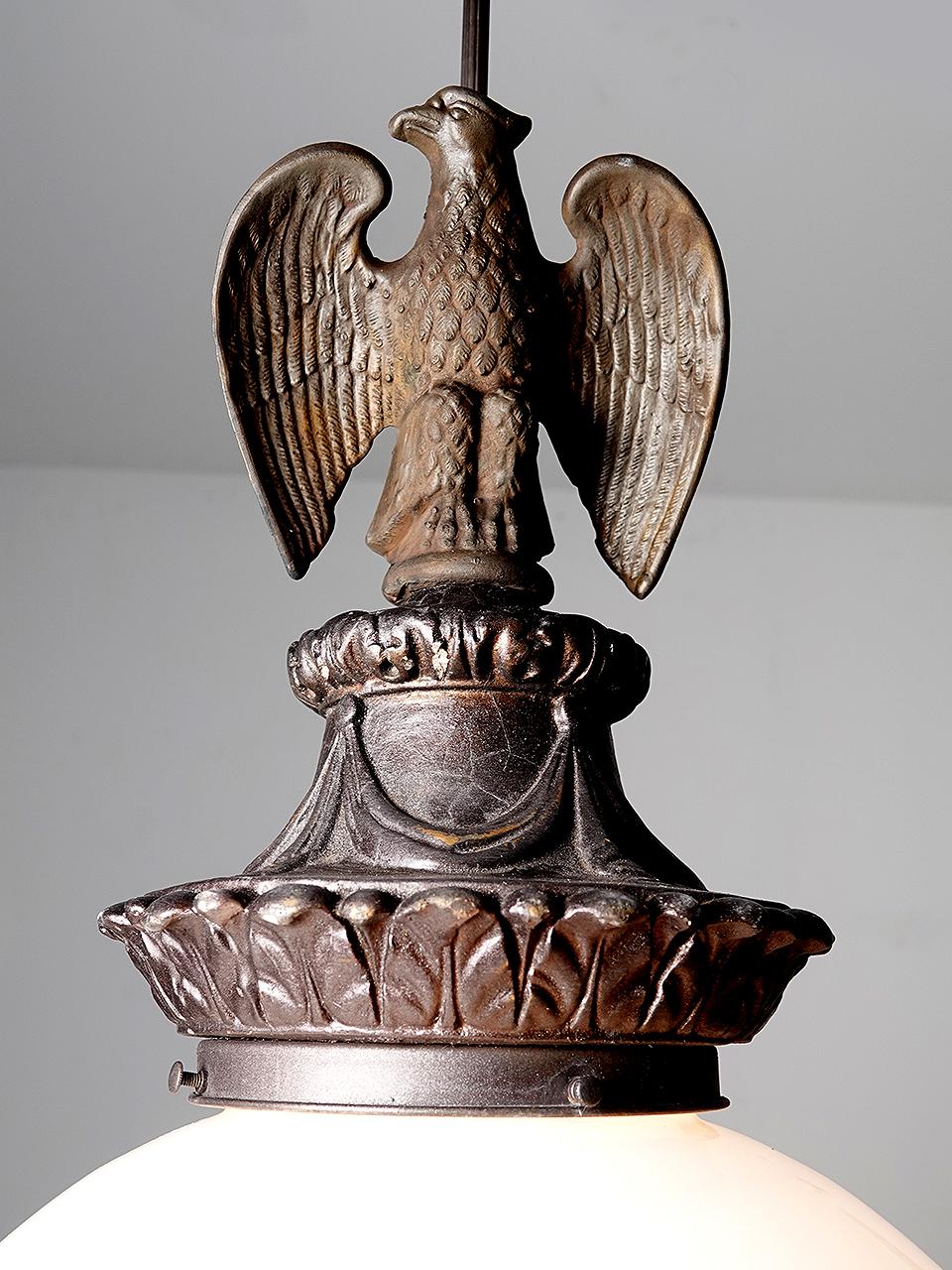 This lamp features a 16 inch diameter milk glass globe. I think thats the largest globe we have ever offered and it does make a statement. The decorative elements definitely say municipal building or bank. The impressive eagle on top is prominent