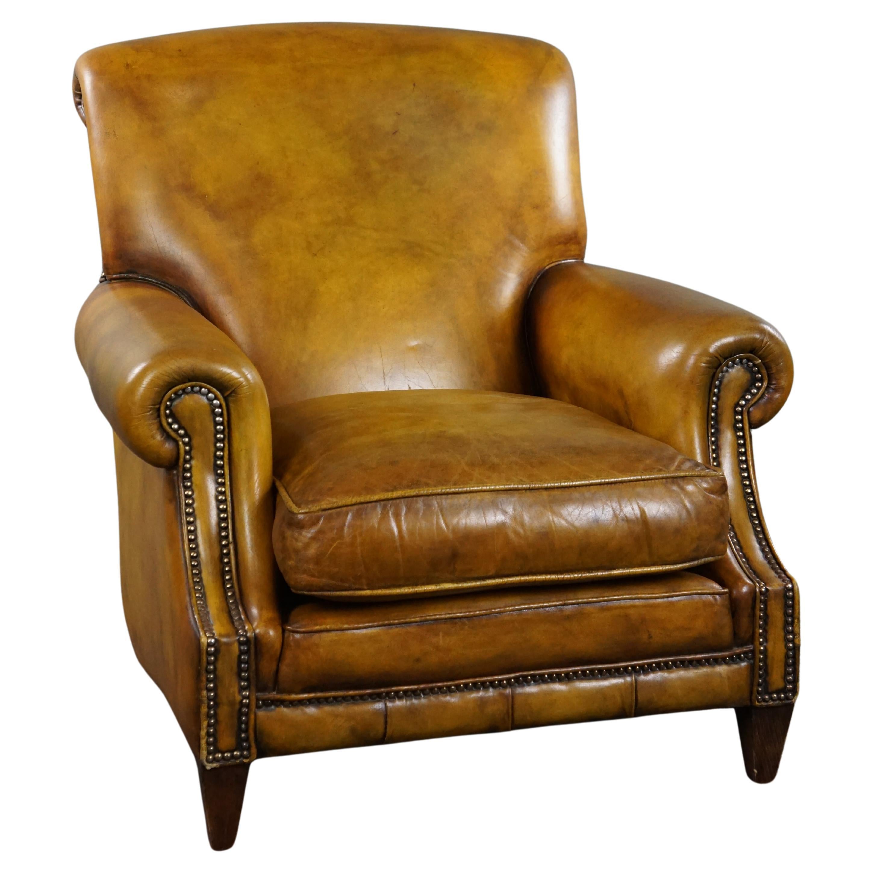 Large cowhide armchair on wheels For Sale