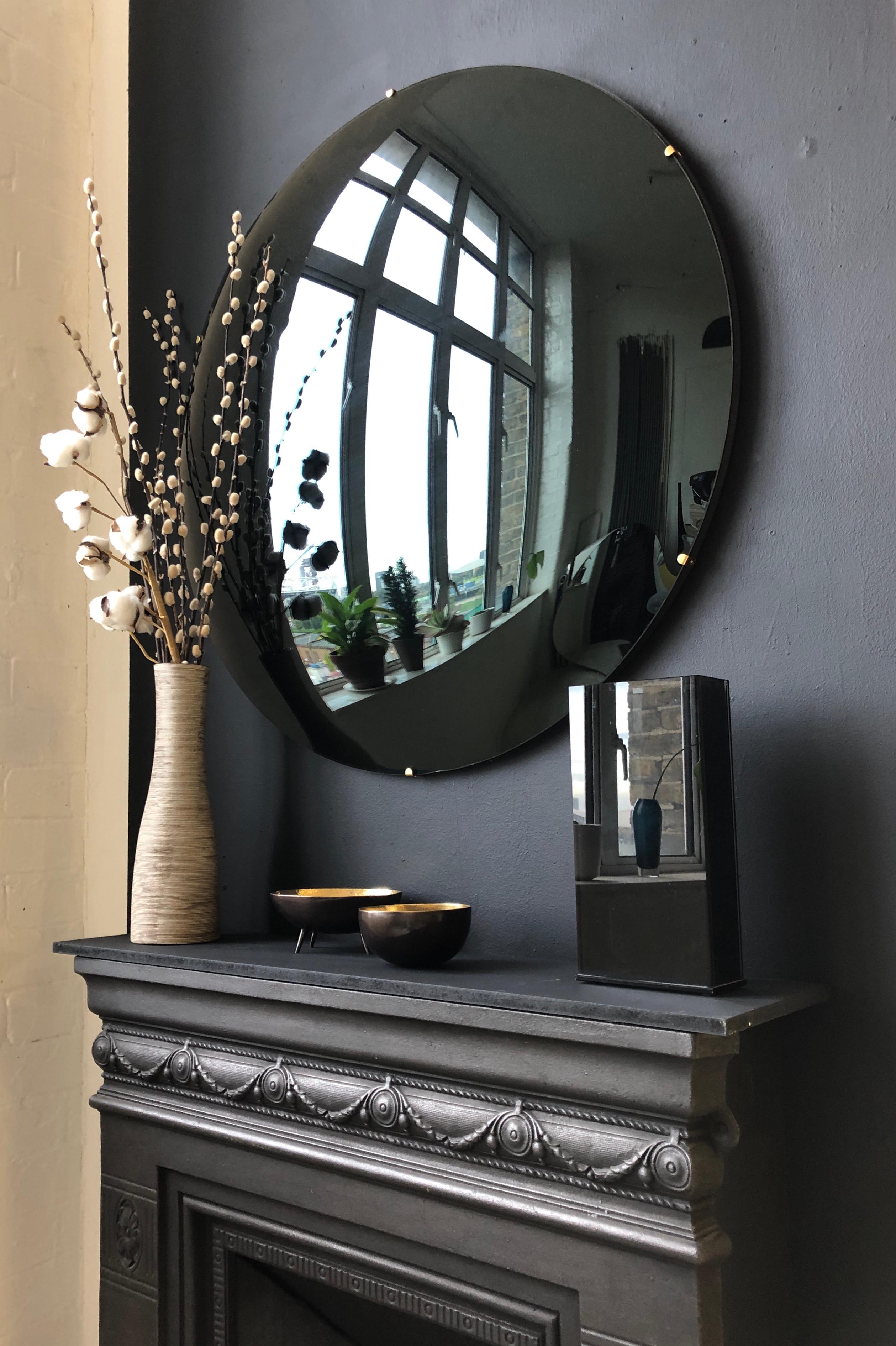 Stunning frameless black convex mirror for a unique statement above a fireplace, a console table or anywhere in a home, hospitality or commercial space.

Each Orbis™ convex mirror is designed and handcrafted in London, UK. Slight variations in
