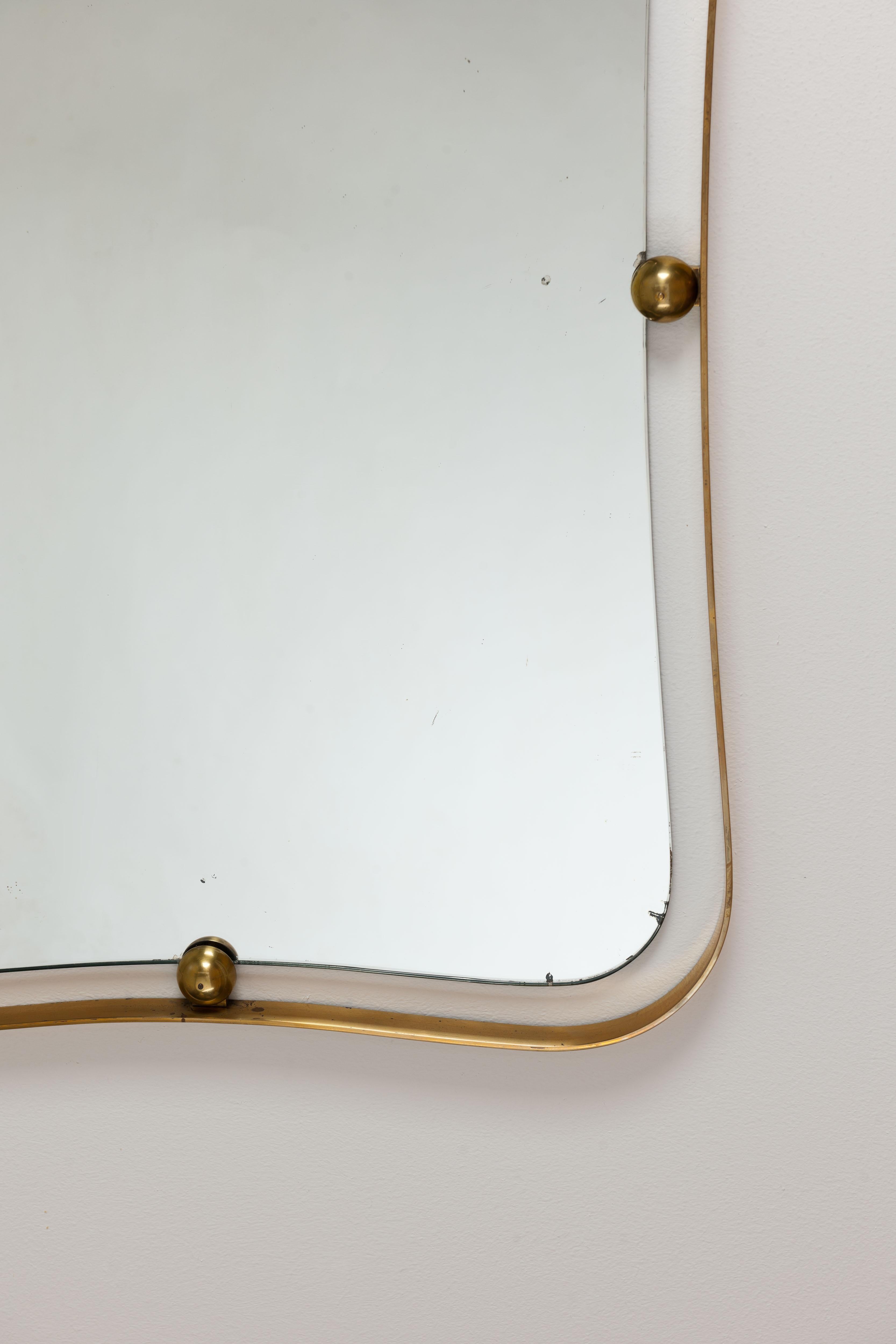 Beautiful large very high quality artisanal crafted brass Italian mirror from the mid-1960s. Executed from very heavy quality brass. Constructively very well designed.
The mirror is mounted blind on the wall, this way the mirror looks beautiful as