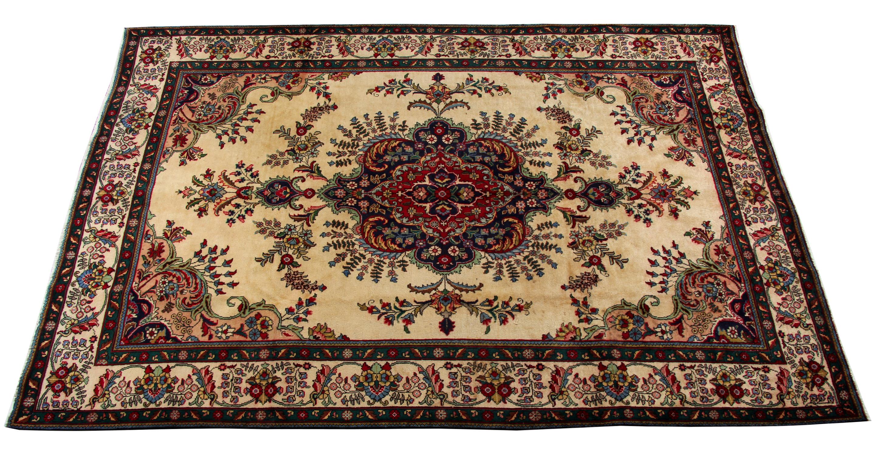 This beautiful design is a fantastic example of handwoven rugs from the 1970s. It features a tremendous central medallion adorned with flowers and foliate scrolls. The accent colours of blue. red, orange and green contrast beautifully with the