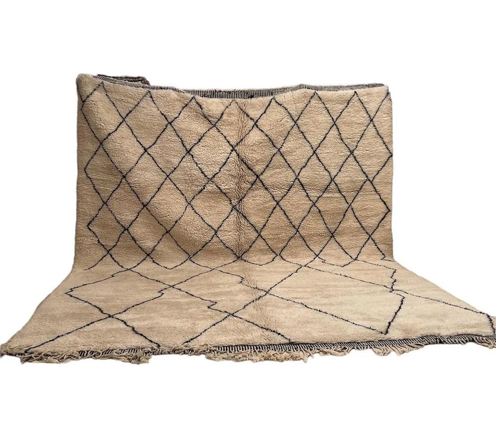 This large cream neutral handwoven Beni Ourain rug was made by hand by skilled artisans in the Atlas Mountains using the highest quality Moroccan wool. It is impressive in both size and design, and is the perfect luxury statement piece for any room.