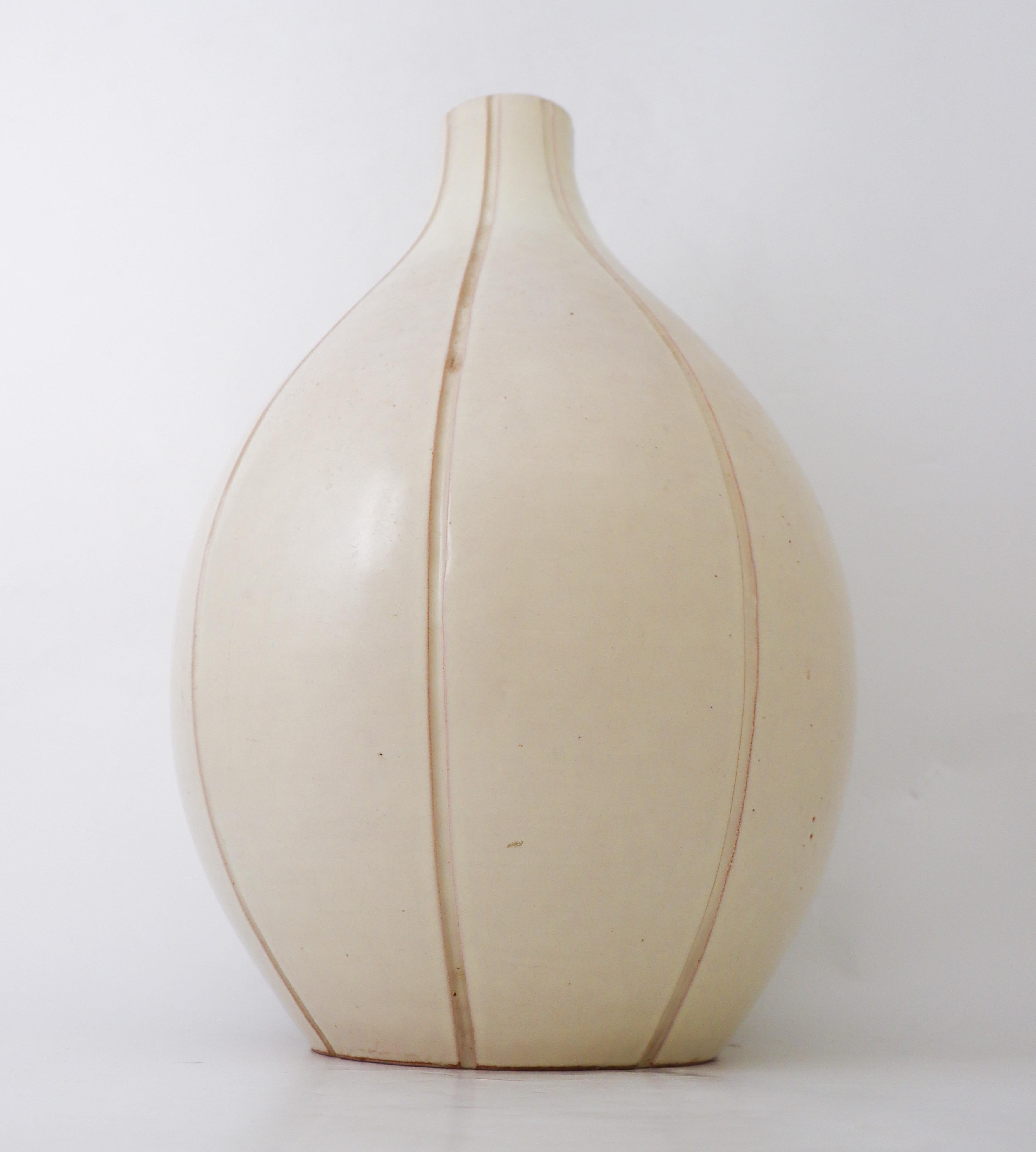 A large creme-colored floor vase designed by Erik Ivarsson at Andersson & Johansson in Höganäs, Sweden. The vase is 47 cm high and in excellent condition except from a minor un-glazed mark in the glaze from the production.