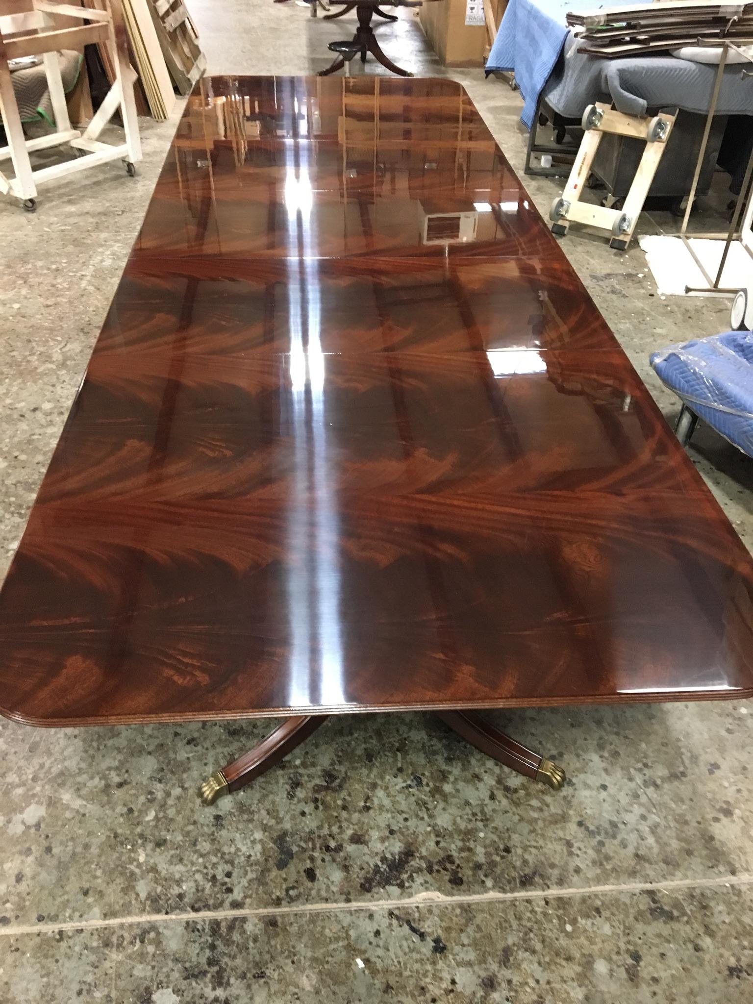 This is a made-to-order Large Traditional mahogany banquet/dining table made in the Leighton Hall shop. It is modeled after the understated swirly crotch mahogany tables made in the 1800s and early 1900s. It features a field of slip-matched swirly