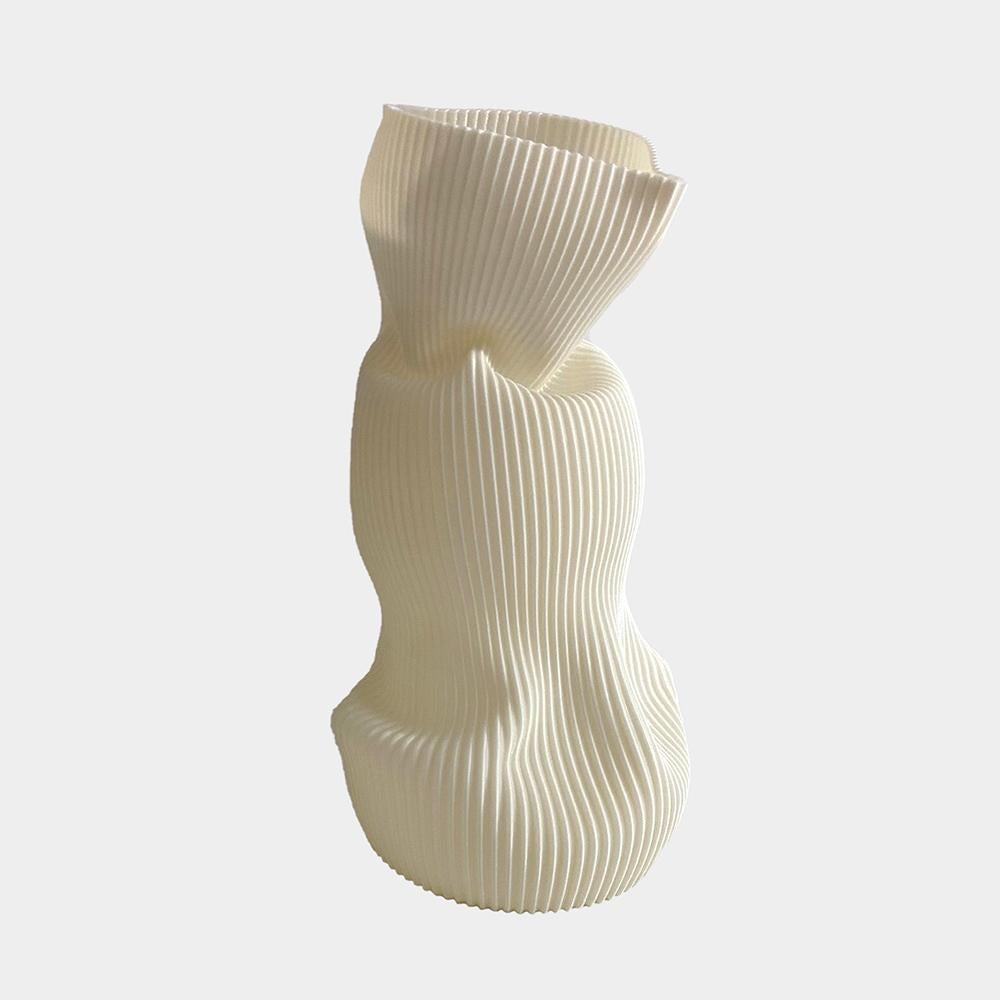 3D-printed in bioplastic and hand-shaped, the Crumpled Vase combines digital precision with expressive craftsmanship. Its sculptural form and delicate texture make each piece a one-of-a-kind creation, individually molded by the artist’s hands.

Made