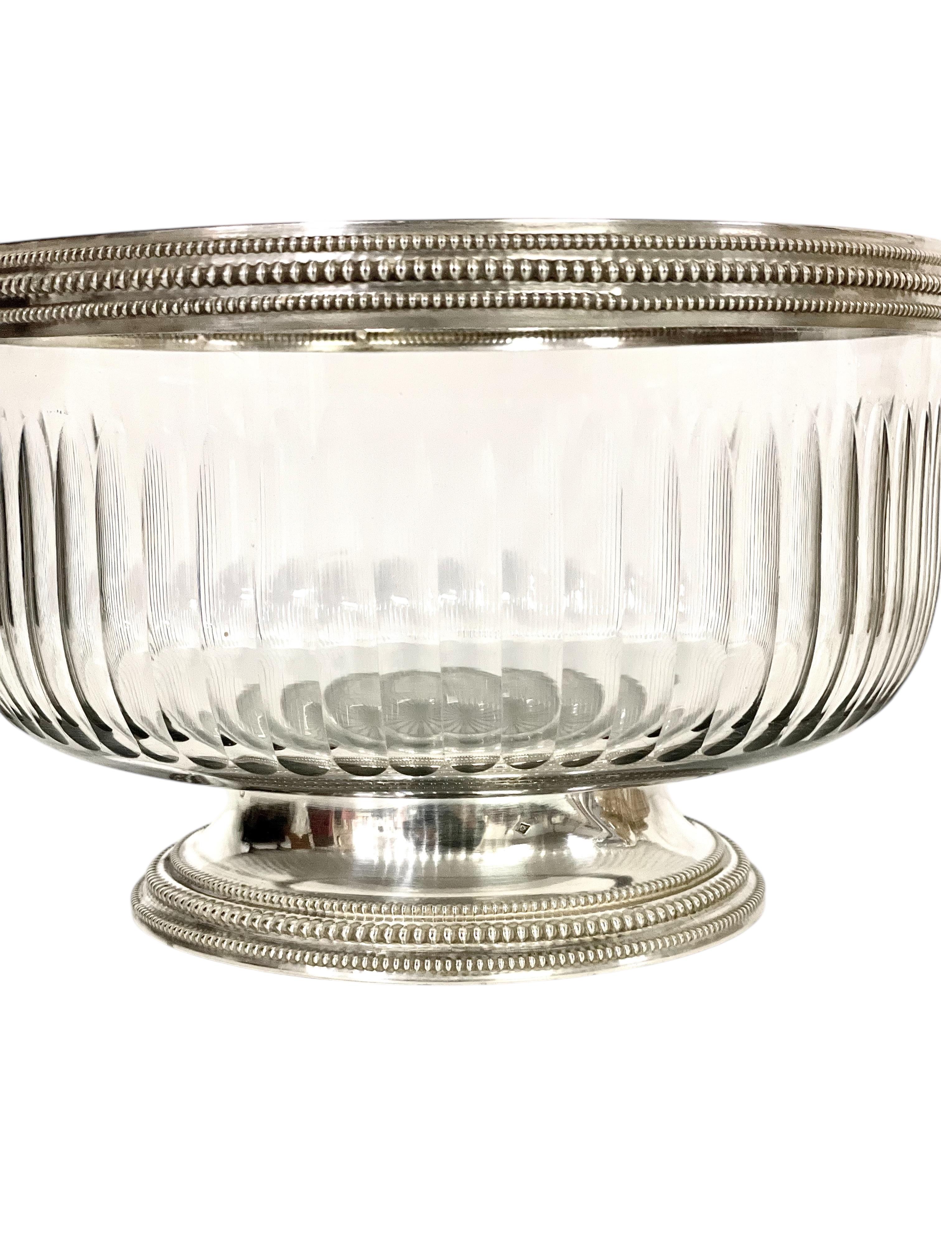 This exquisite French bowl combines the clarity and brilliance of cut crystal with the timeless elegance of sterling silver. Crafted in France, likely in the late 19th or early 20th century, the bowl features a fluted crystal body with beautifully