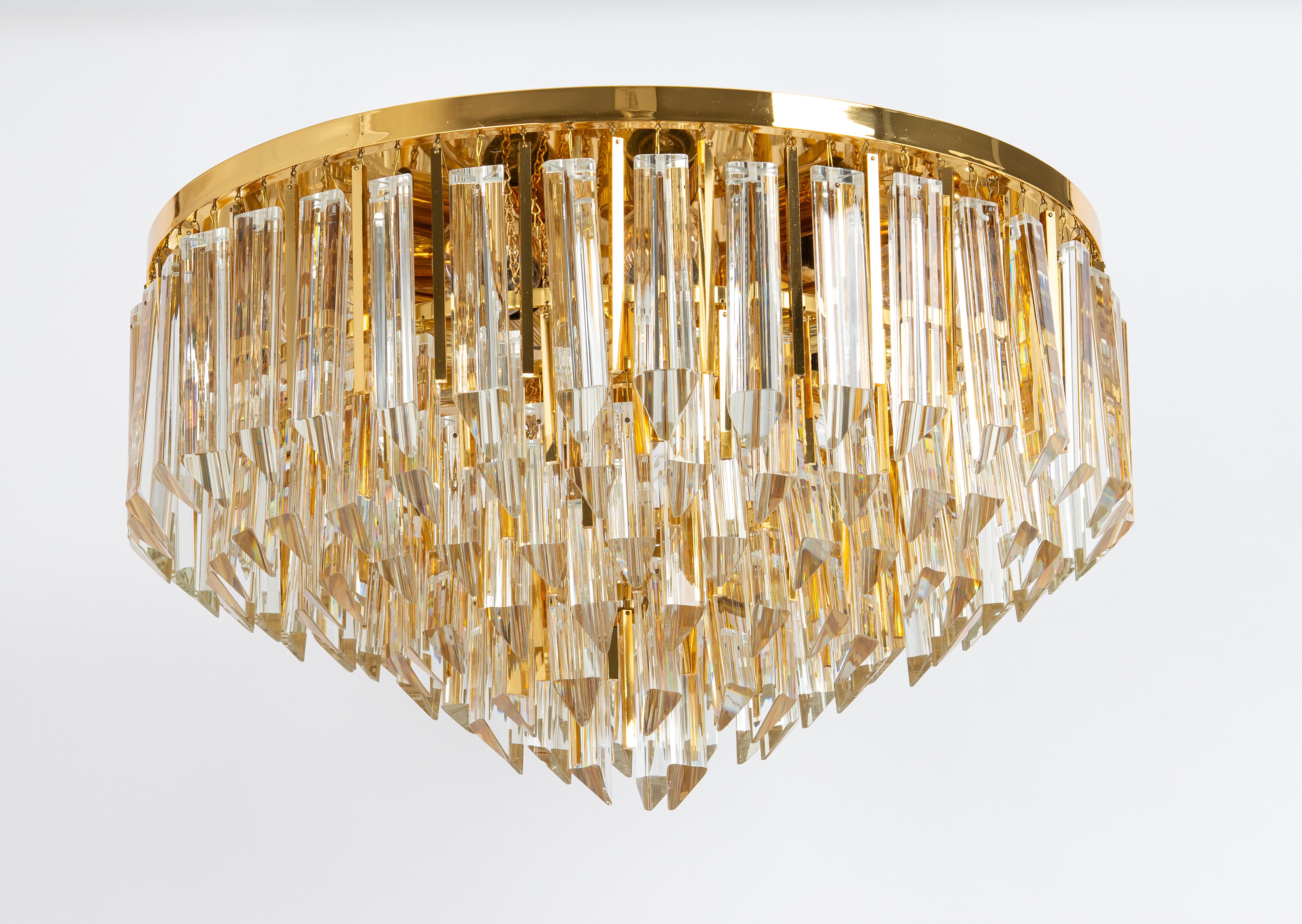 A wonderful flush mount light fixture by Palwa, Germany, 1970s.
It is made of a brass frame decorated with a large number of crystals. Wonderful light effect.

The lamp takes 9 x E27 Standard Bulbs ( up to 80 W  each ) + 1 x E14 (Small Bulb up to 40