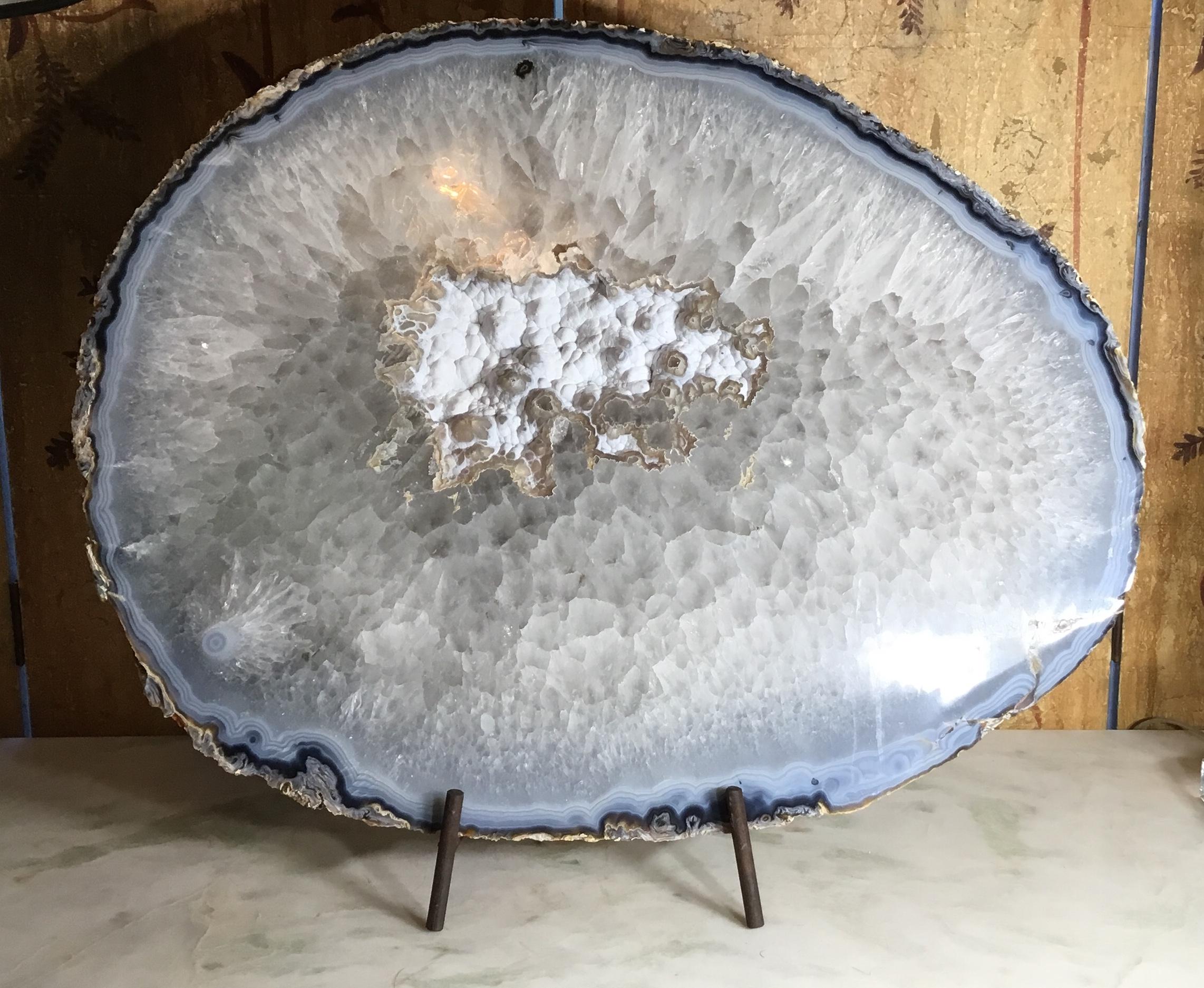 Fantastic large crystal quartz agate cut and polish to make one of a kind beautiful object of art for display ,off white ,gray-light blue color 
Make it perfect for room decoration.
Mounted on custom made steel display piece, which is included.