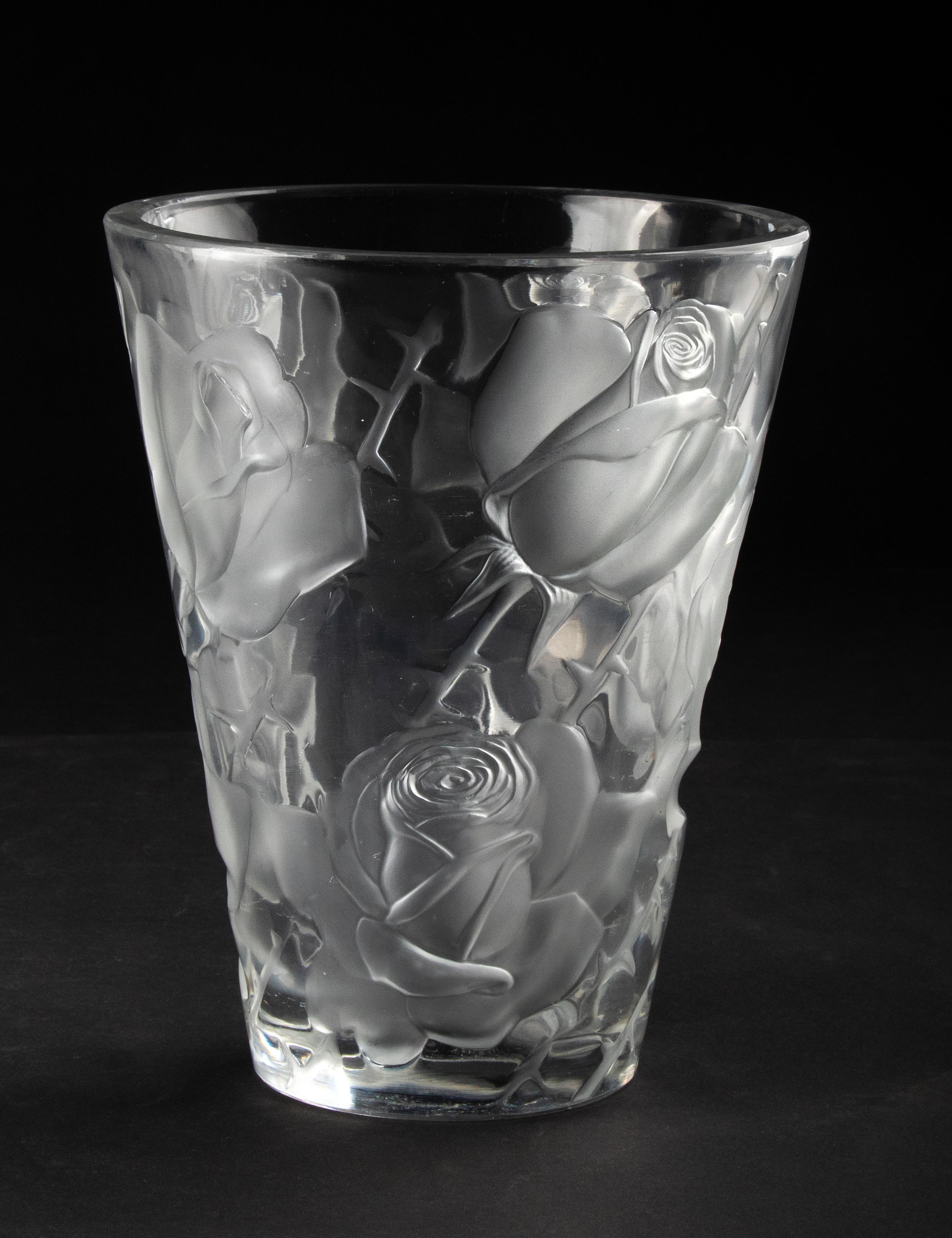 Large crystal vase by the French maker Lalique. The vase is decorated with a rich and full pattern of roses, the name of this model is Isphan. Ispahan refers both to a name of a rose and a city in Iran.
The vase is signed on the bottom. The vase is