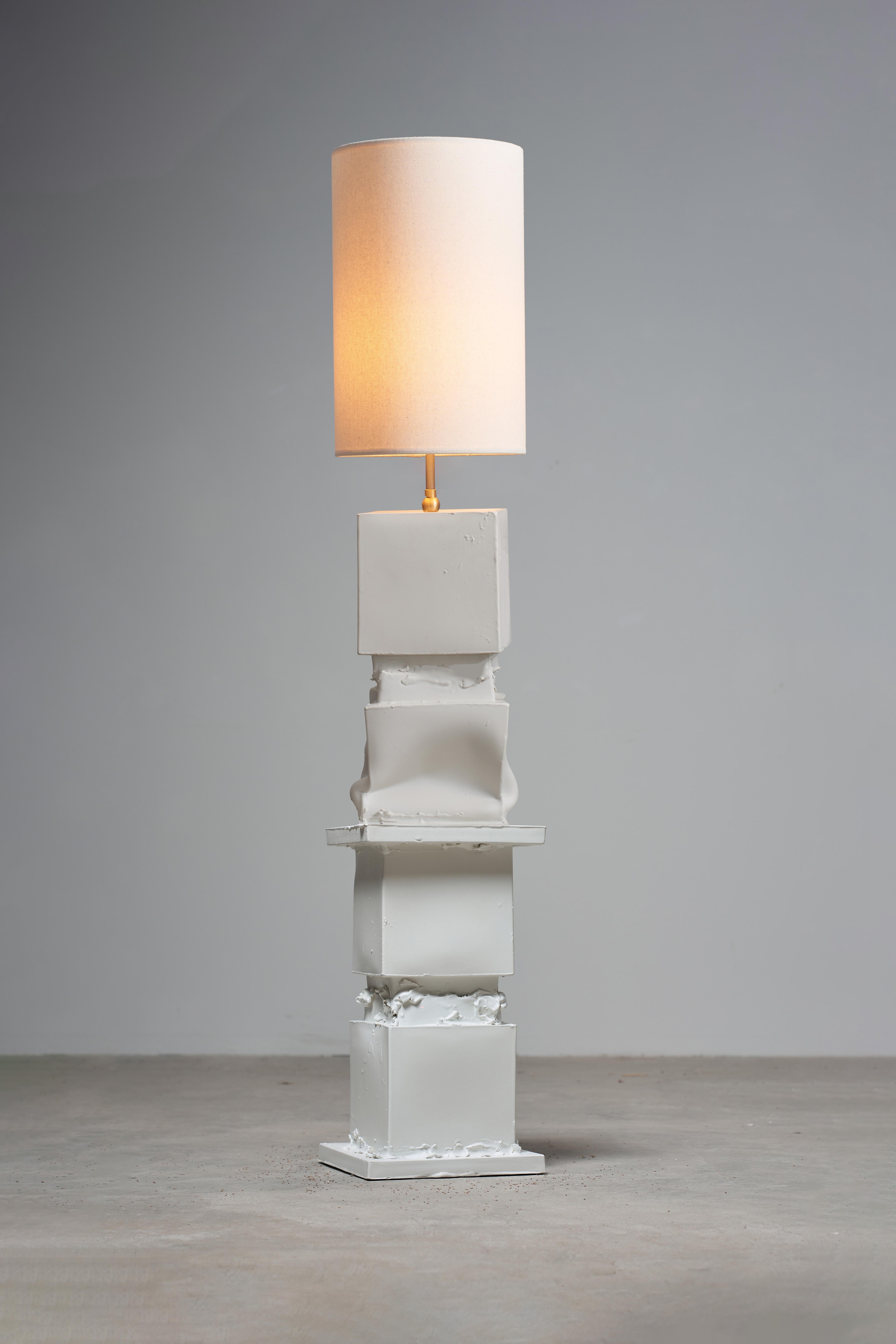 
This sculptural floor lamp is built from four stacked cube forms, each named after Marostica, a historic town near the ceramic atelier where the piece is made. The cubes are crafted from reimagined plaster molds—broken apart, bent, peeled back, and