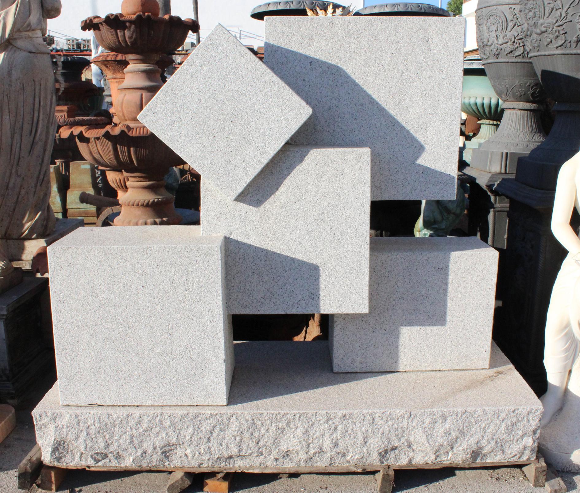 Large cuboid modernist grey granite sculpture.