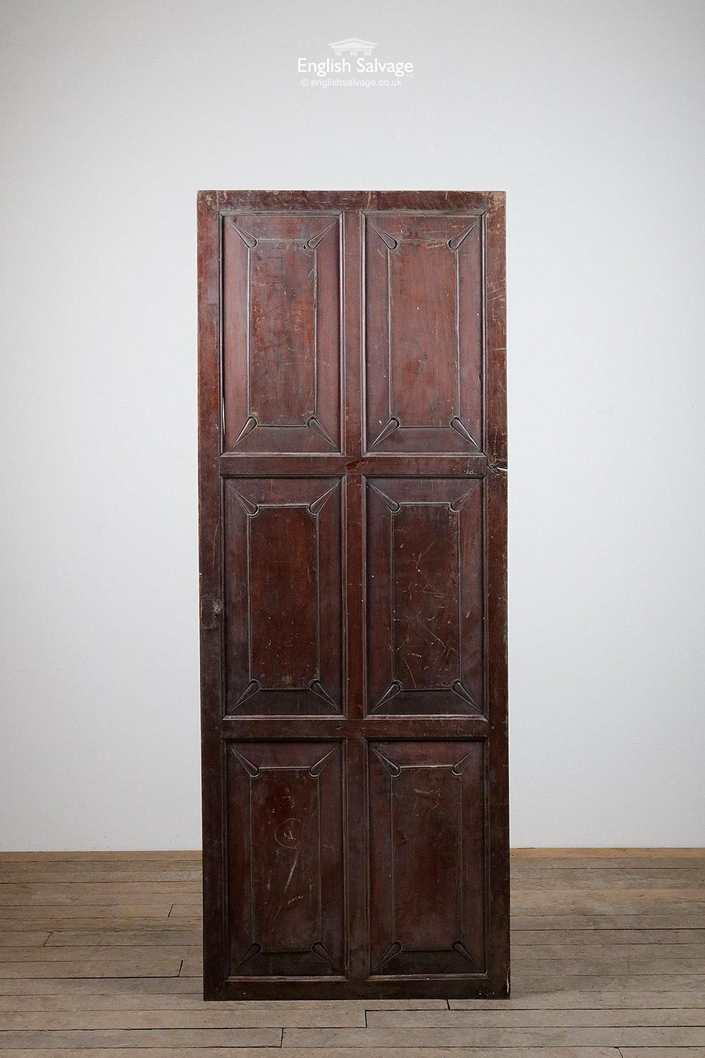 Large sized attractive four panel hardwood cupboard door / panel. Probably teak or a similar red hardwood. Unusual and ornate carving to the front panels on the front face, plain panels to the rear. This has been varnished, which is worn in places.