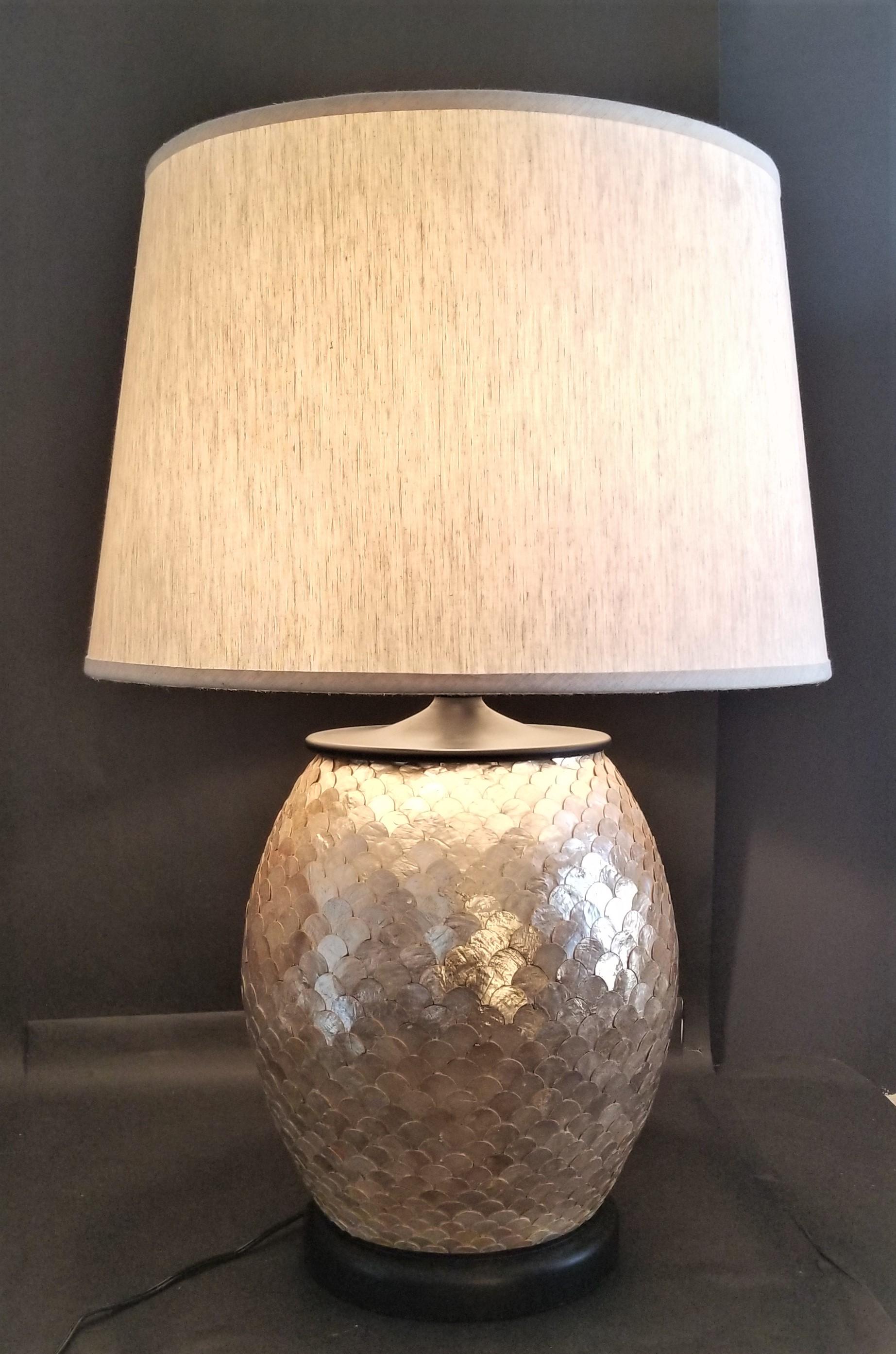 Offering one of our recent palm beach estate fine lighting acquisitions of a
Currey & Company alfresco lamp matte black with iridescent capiz shells with shade

This Currey & Company Lamp is extra large and features a matte black wood base and