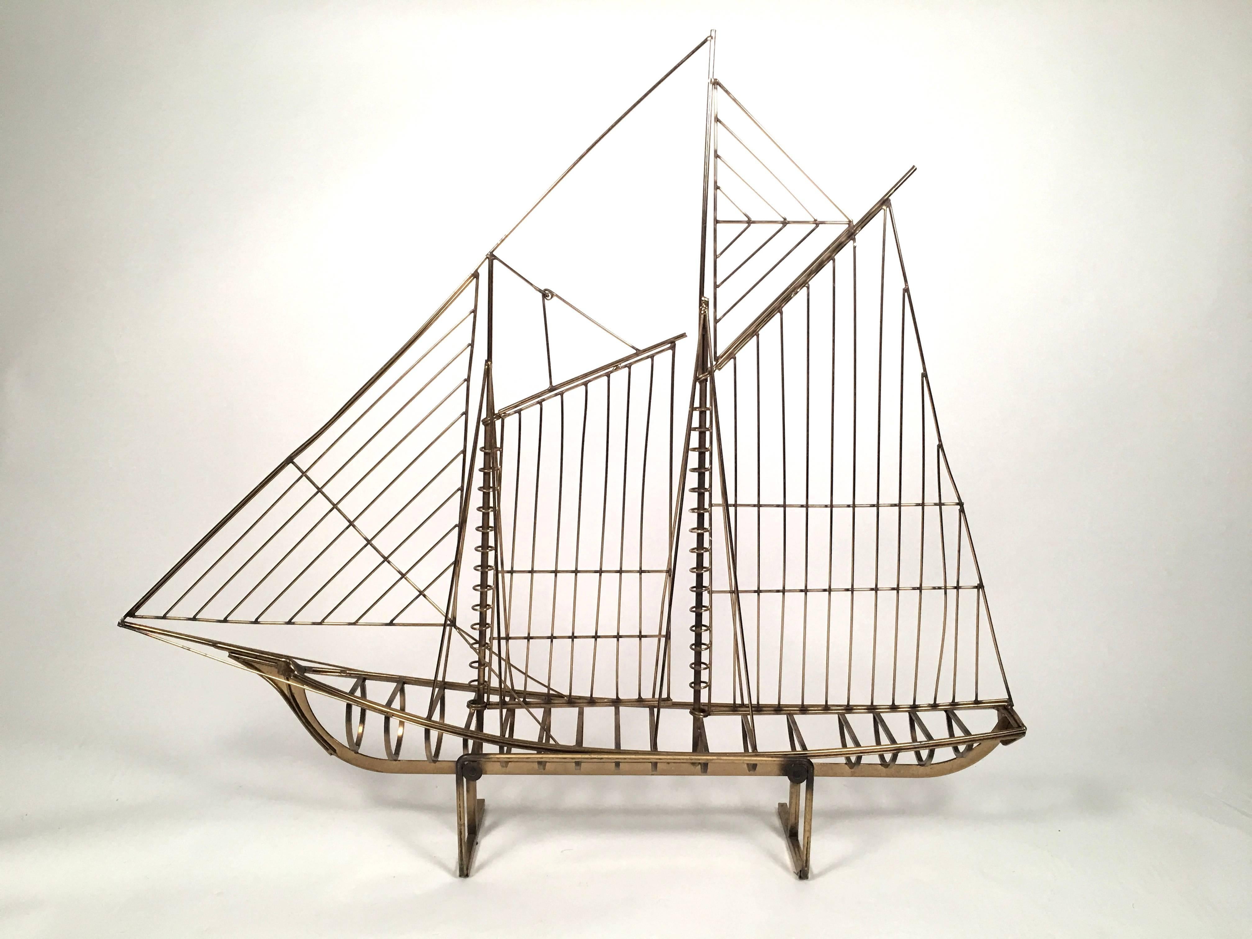 A large, original Curtis Jere brass ship sculpture in brass, the two masted schooner at full sail, beautifully modern and simple, yet well detailed, with integrated stand so that it may be displayed easily on a table or mantel. Signed C. Jeré and