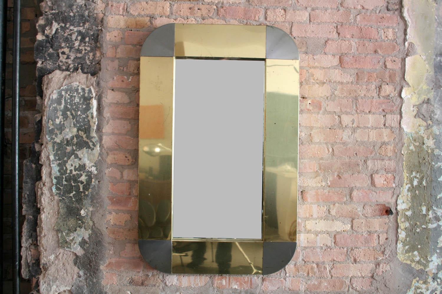 Large Curtis Jere 1970s signed wall mirror in brass. The brass has some patination and minor scratches.